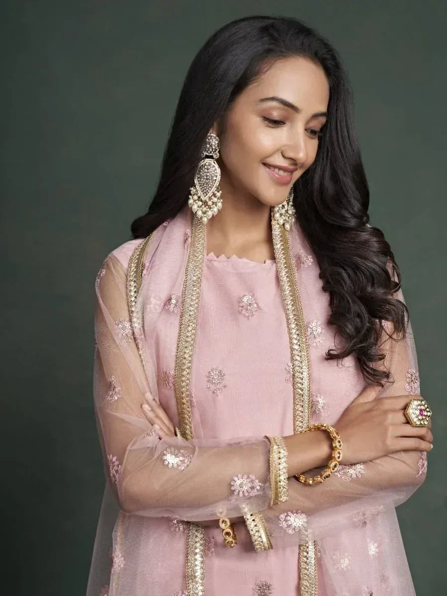 Pink embroidered ethnic salwar kameez with gold trim and statement jewelry