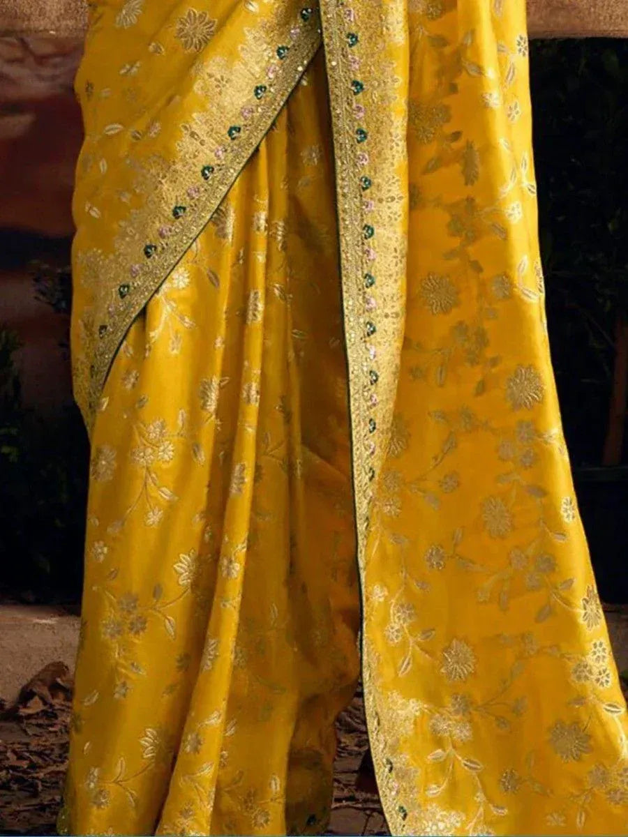 Yellow floral embroidered saree with golden border and stone detailing, ideal for ethnic occasions