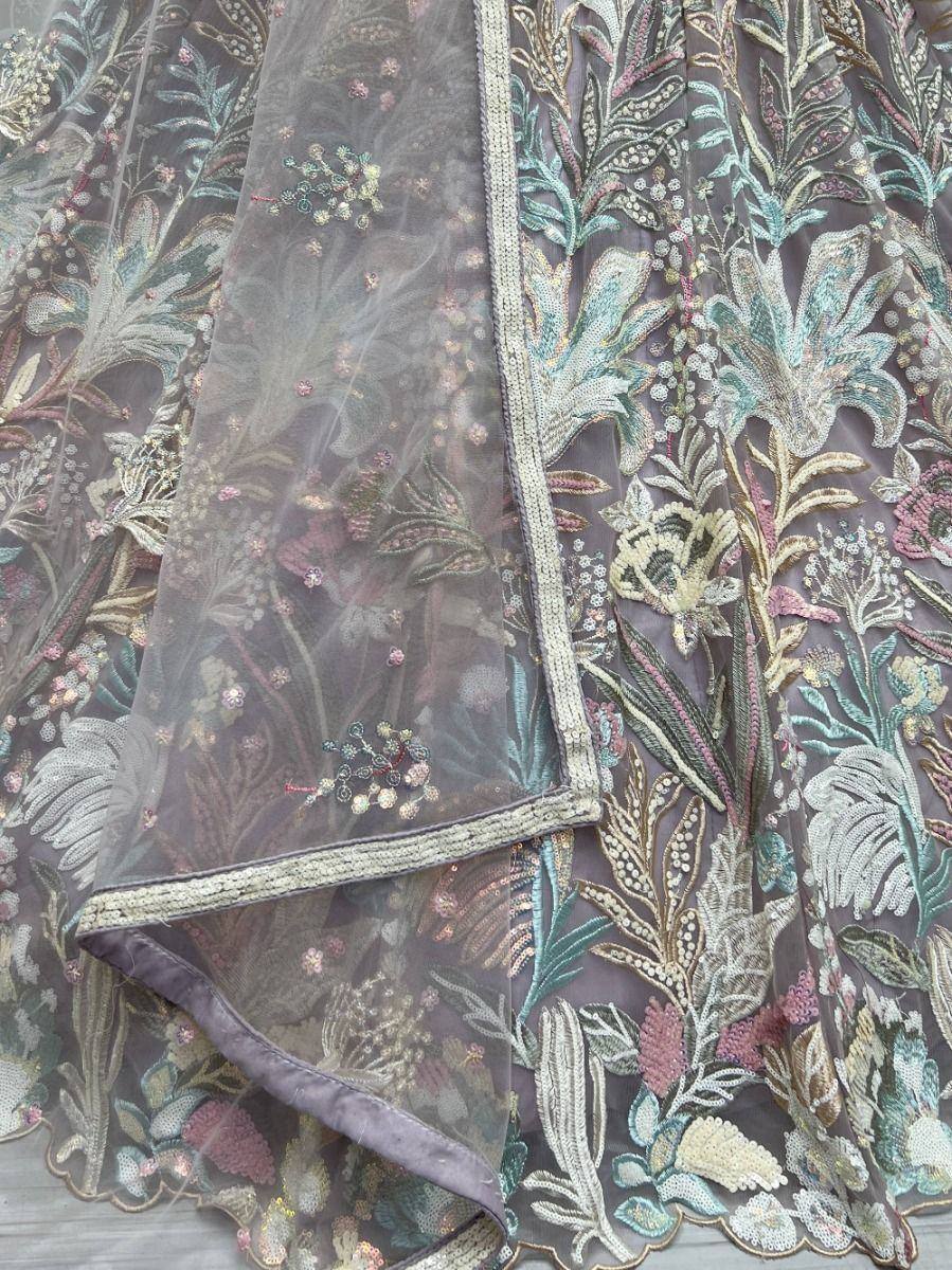 Elegant floral embroidered lehenga with sheer overlay and detailed beadwork in pastel hues
