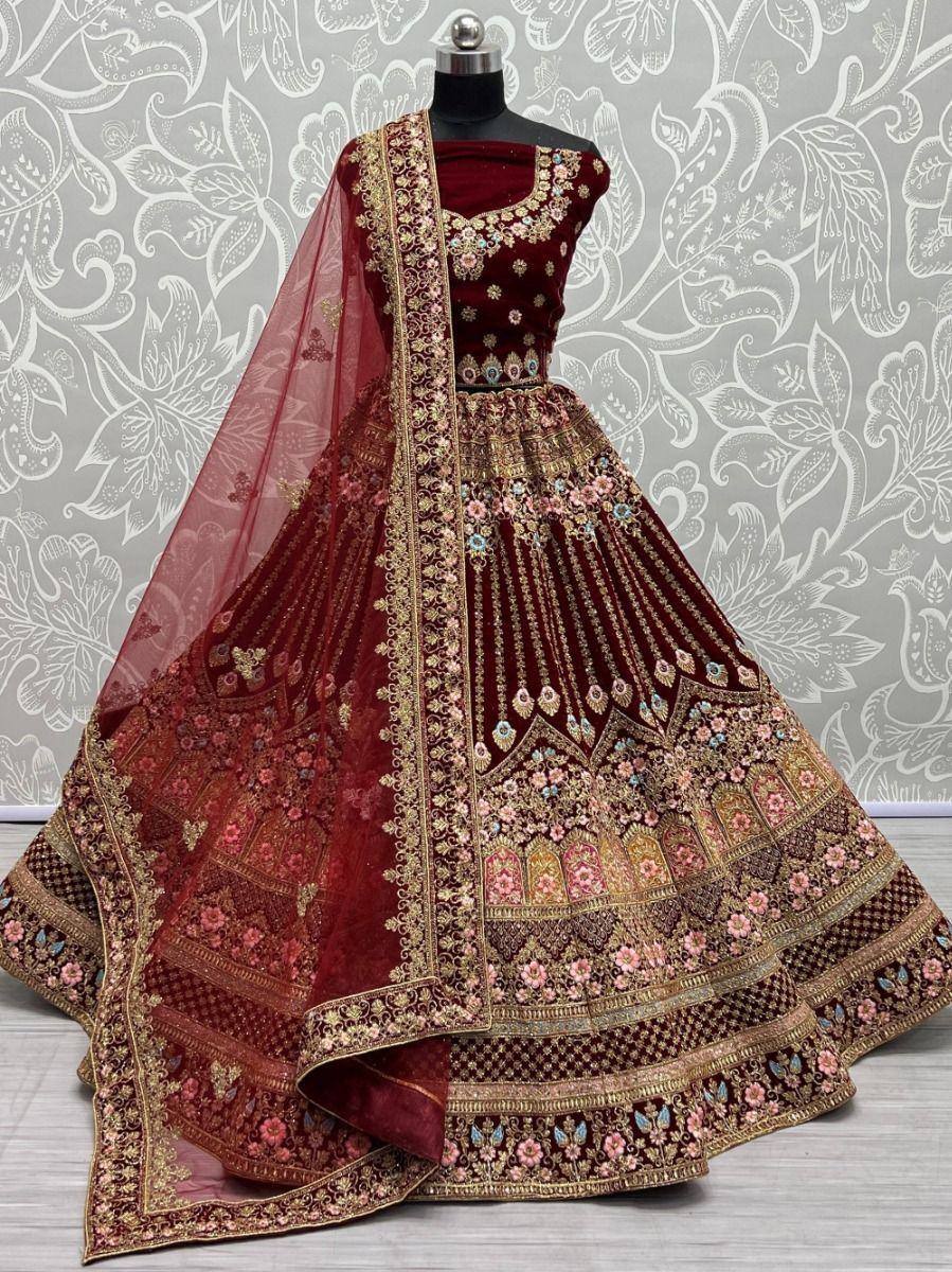 Maroon velvet designer lehenga choli with heavy gold embroidery and floral motifs, perfect for weddings