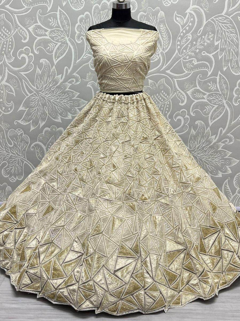 Fascinating Beige Sequins Embroidered Net Lehenga Choli