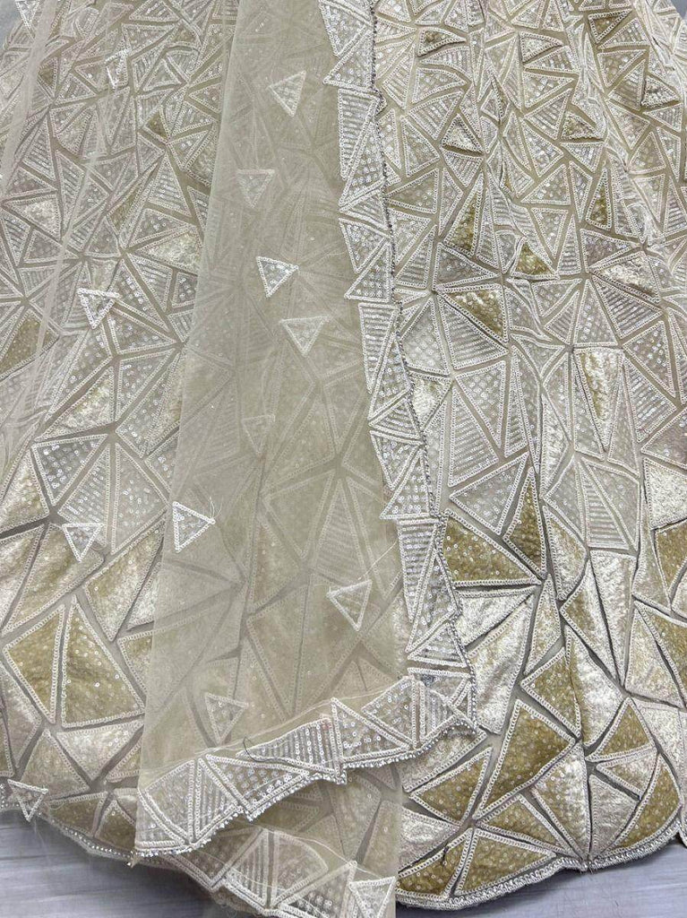 Fascinating Beige Sequins Embroidered Net Lehenga Choli