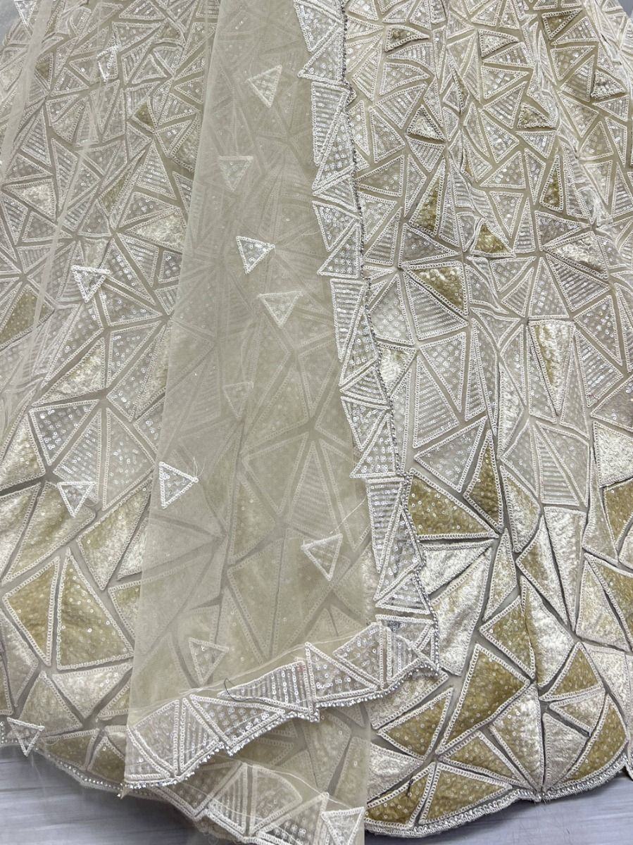 Fascinating Beige Sequins Embroidered Net Lehenga Choli