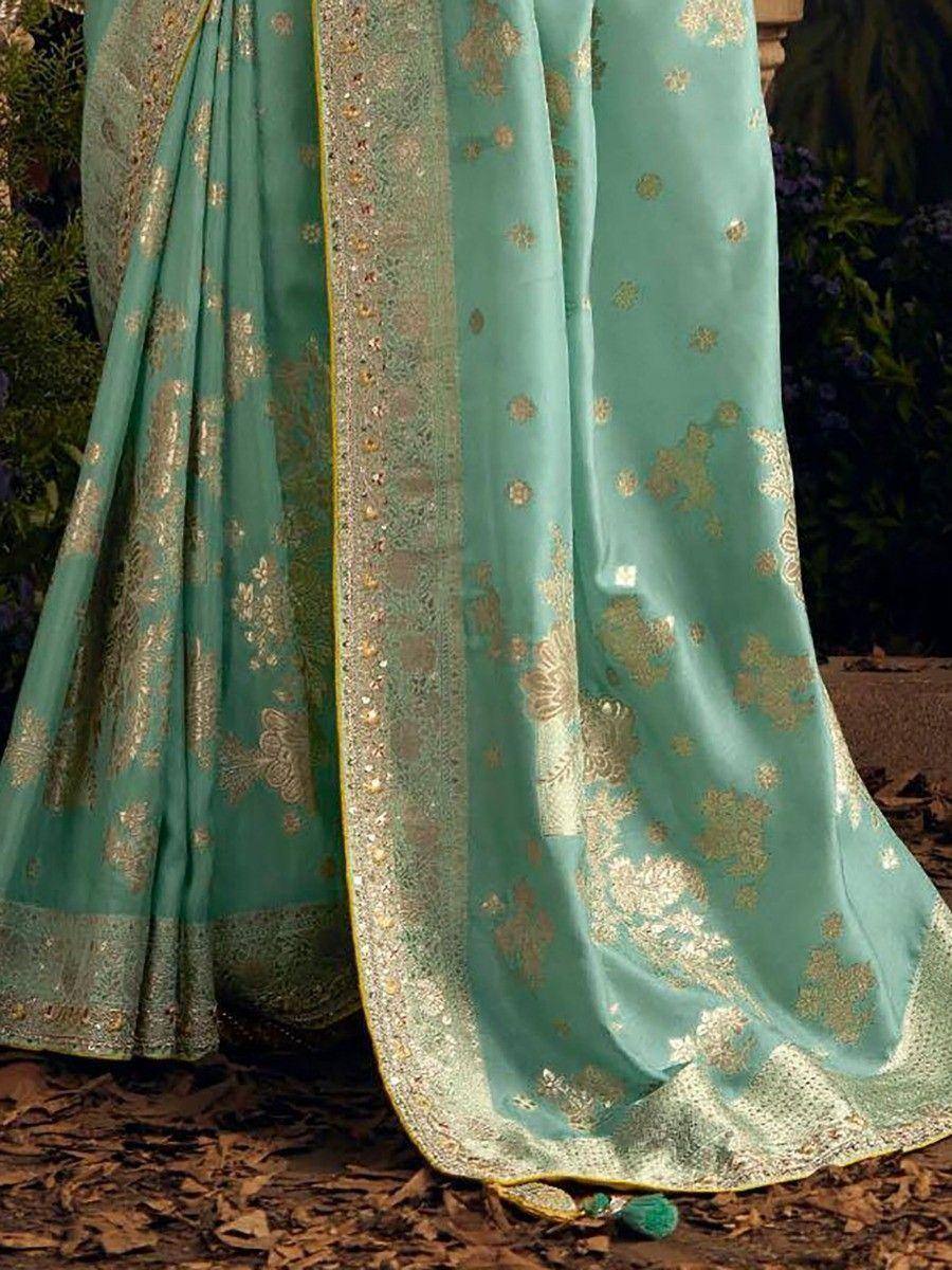 Teal designer saree with gold floral embroidery and intricate border, perfect for ethnic occasions