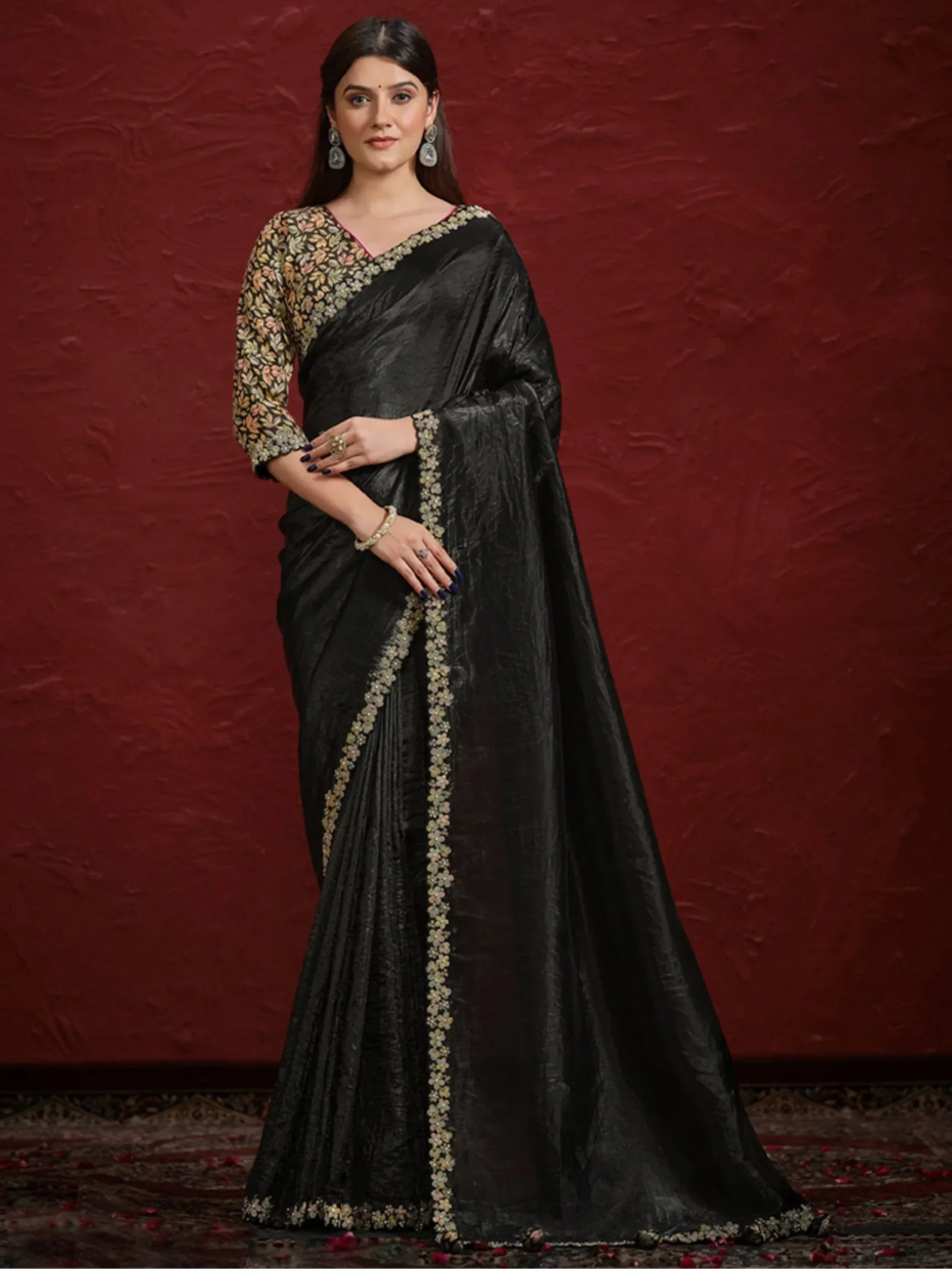 Black designer saree with floral embroidery and embellished border, perfect for ethnic occasions