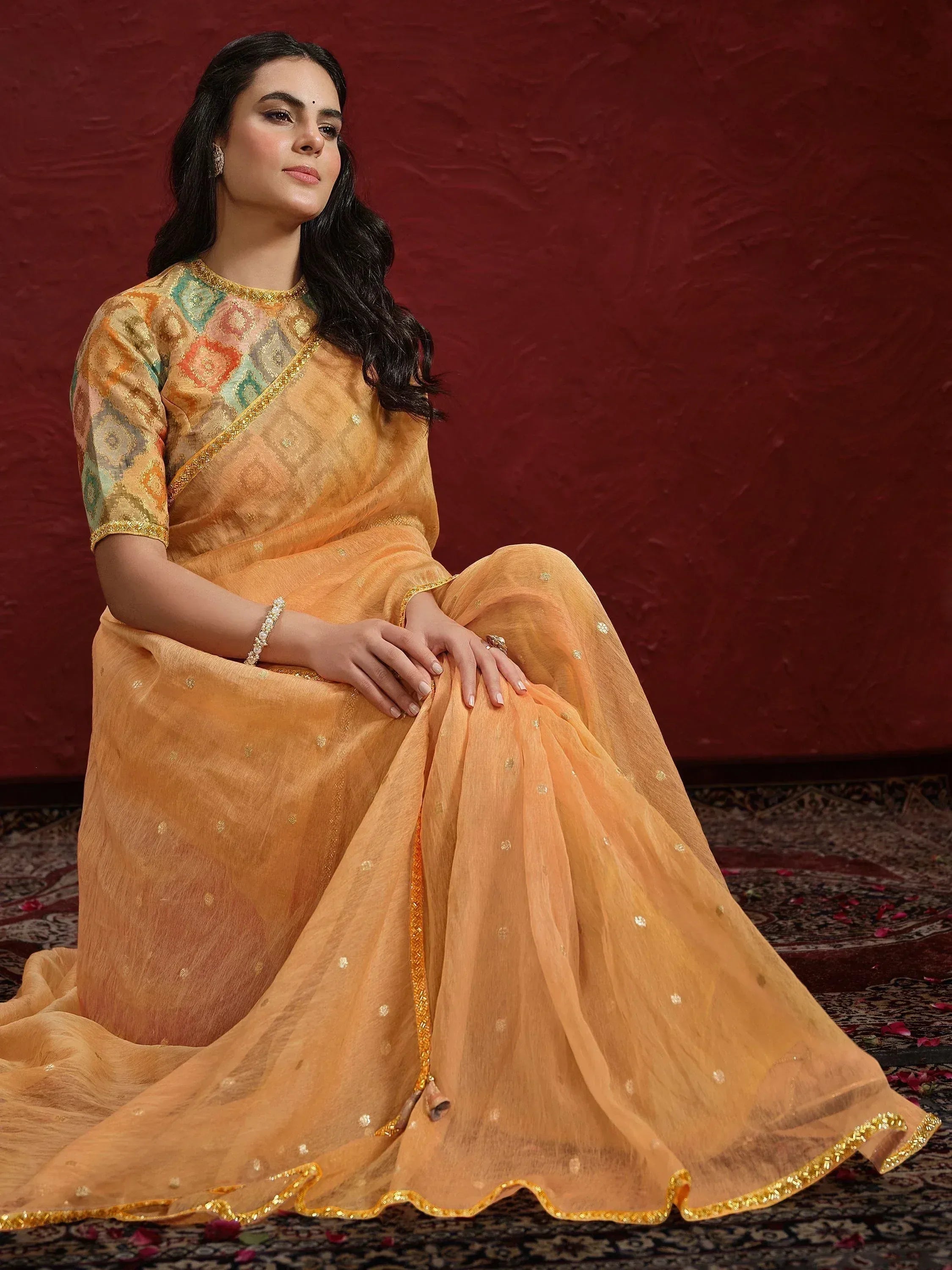Woman in elegant peach saree with gold embroidery, perfect for Indian ethnic occasions