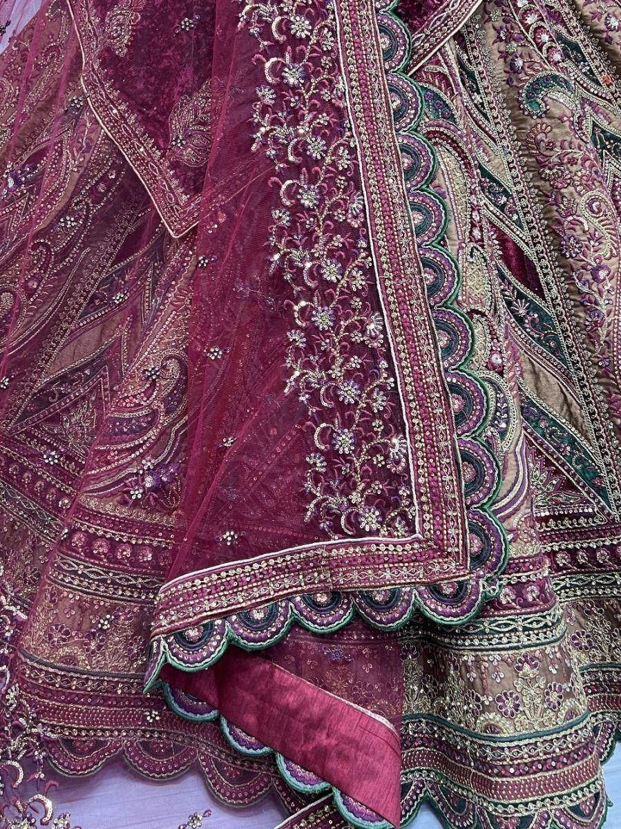 Luxury maroon lehenga choli with intricate gold embroidery and scalloped borders, perfect for weddings