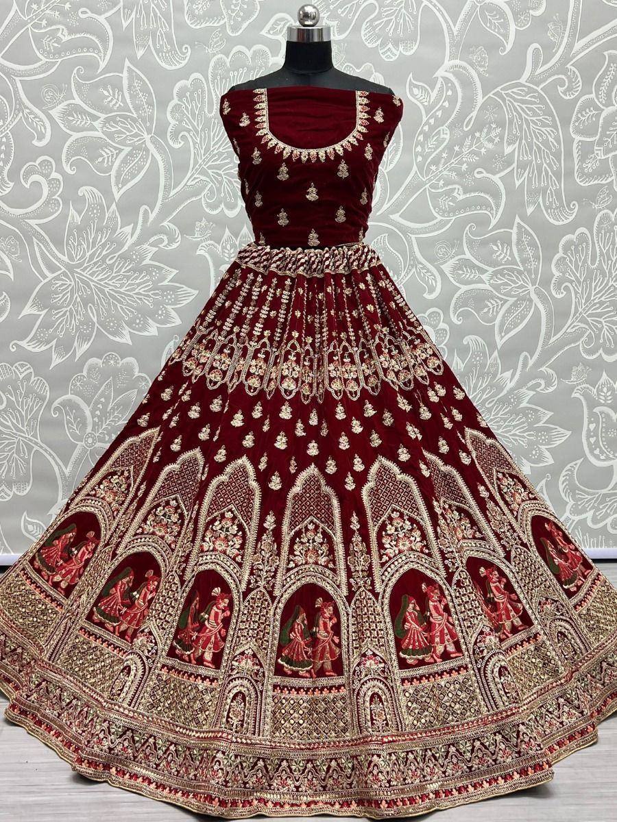 Maroon velvet lehenga choli with gold embroidery and temple motifs, perfect for Indian weddings and festive occasions.