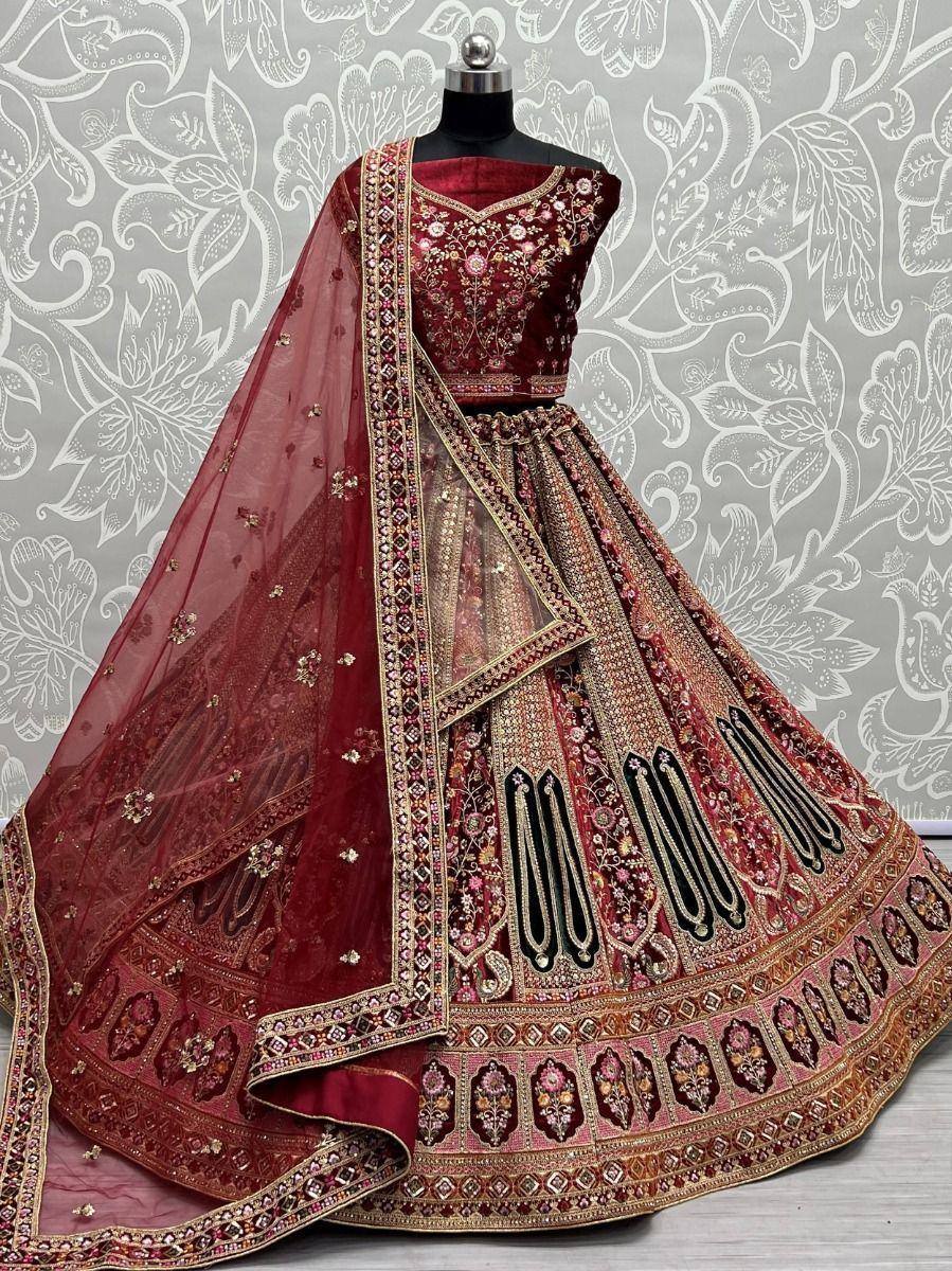 Maroon designer lehenga choli with heavy embroidery and dupatta, perfect for Indian weddings and festive occasions.
