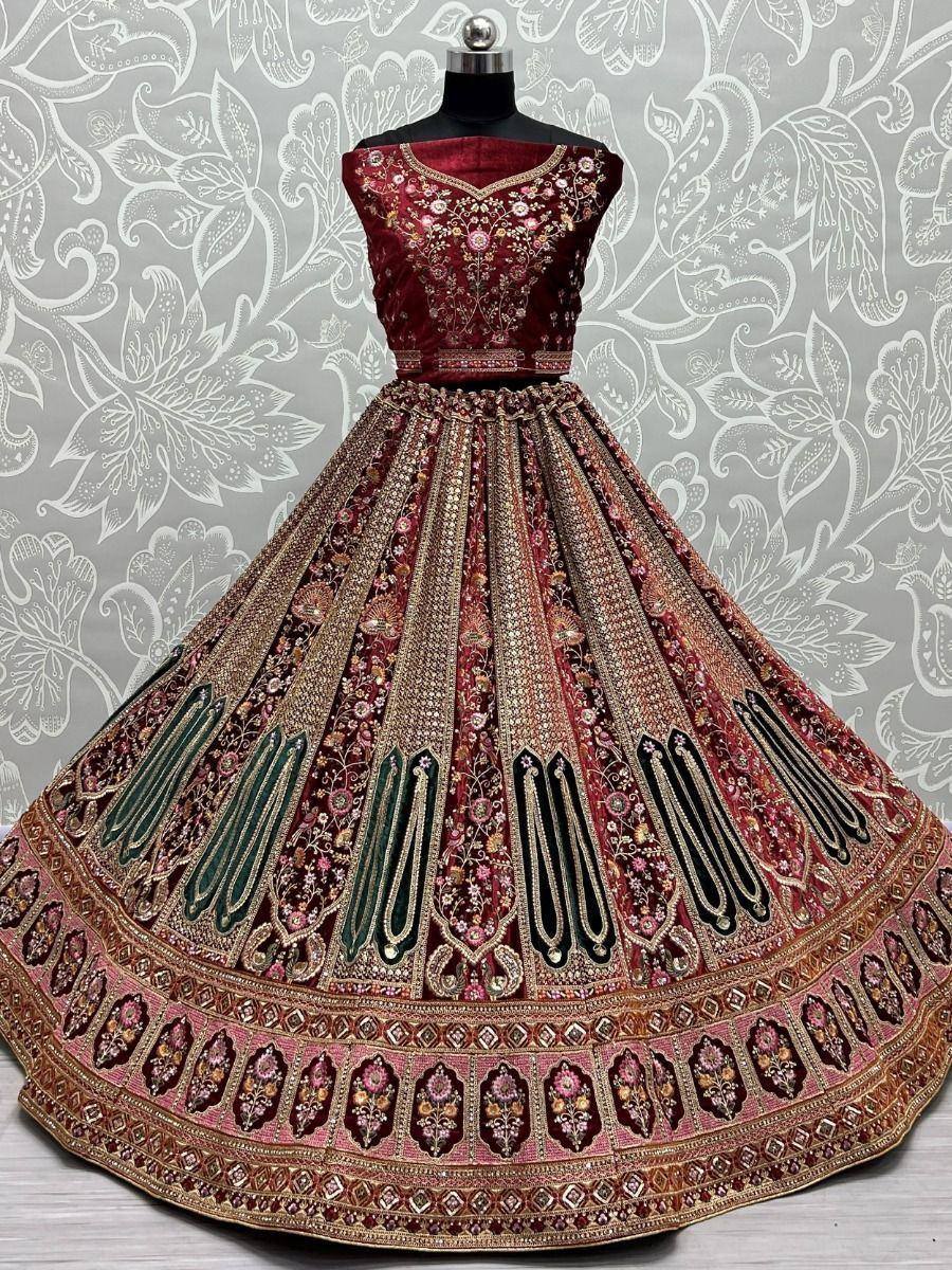 Maroon designer lehenga choli with heavy embroidery and gold detailing, perfect for weddings and festive occasions.