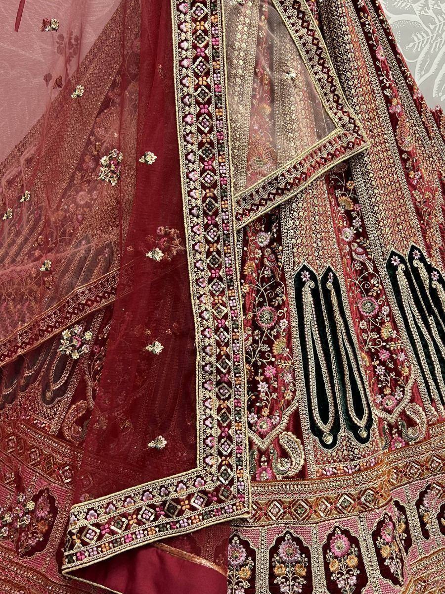 Maroon designer lehenga choli with intricate floral embroidery and gold detailing, perfect for weddings