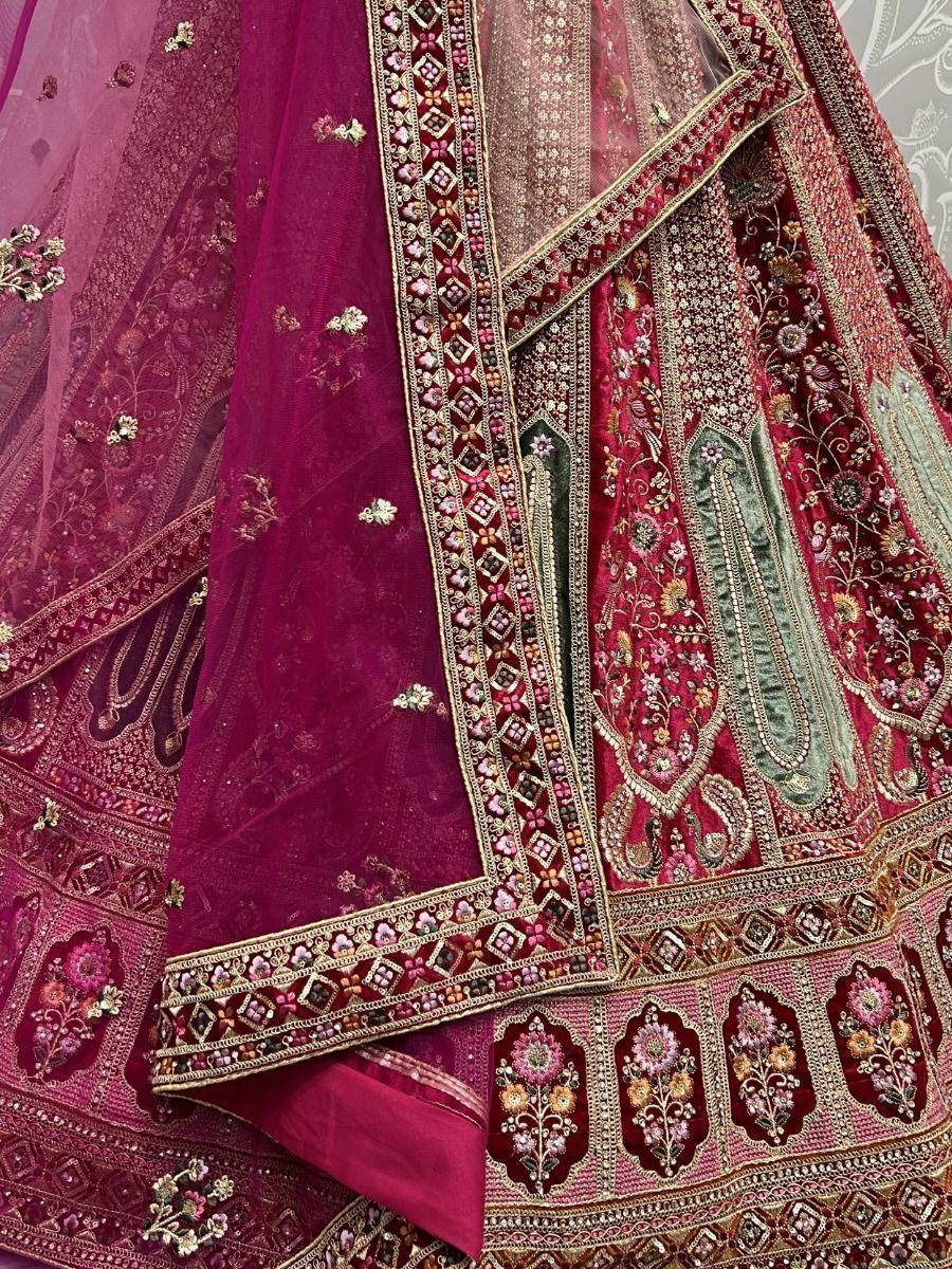 Richly embroidered maroon lehenga choli with floral motifs and gold detailing, perfect for Indian ethnic wear.