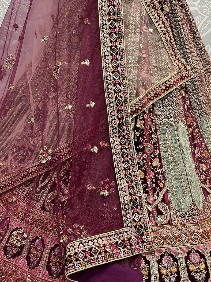 Luxury maroon lehenga choli with intricate floral embroidery and heavy embellishments, perfect for weddings.