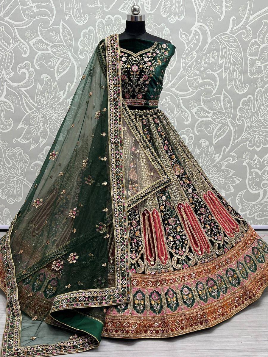Emerald green designer lehenga choli with heavy embroidery and sheer dupatta, perfect for weddings and festive occasions.