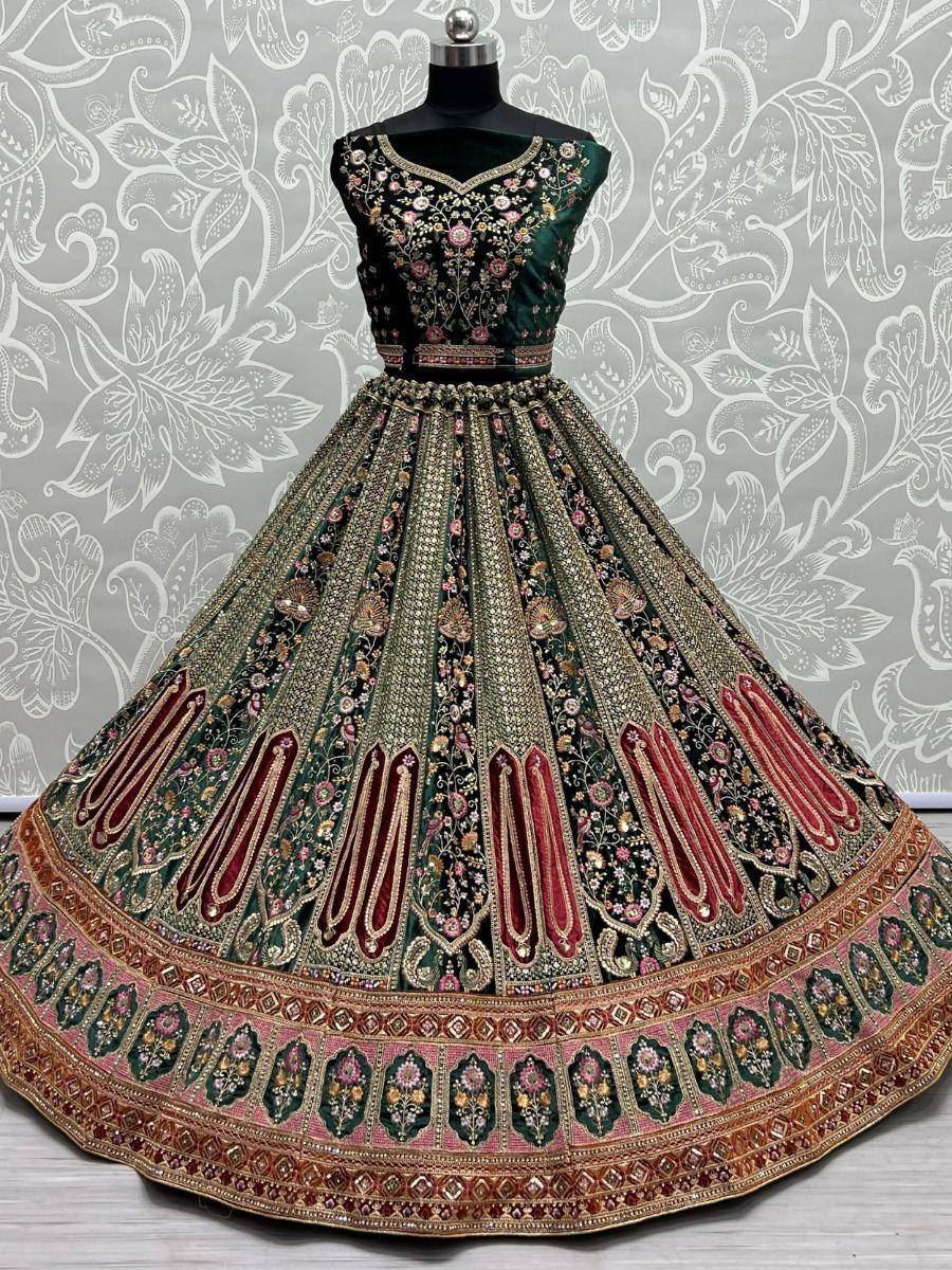 Emerald green designer lehenga choli with heavy floral embroidery and gold detailing, perfect for Indian weddings.