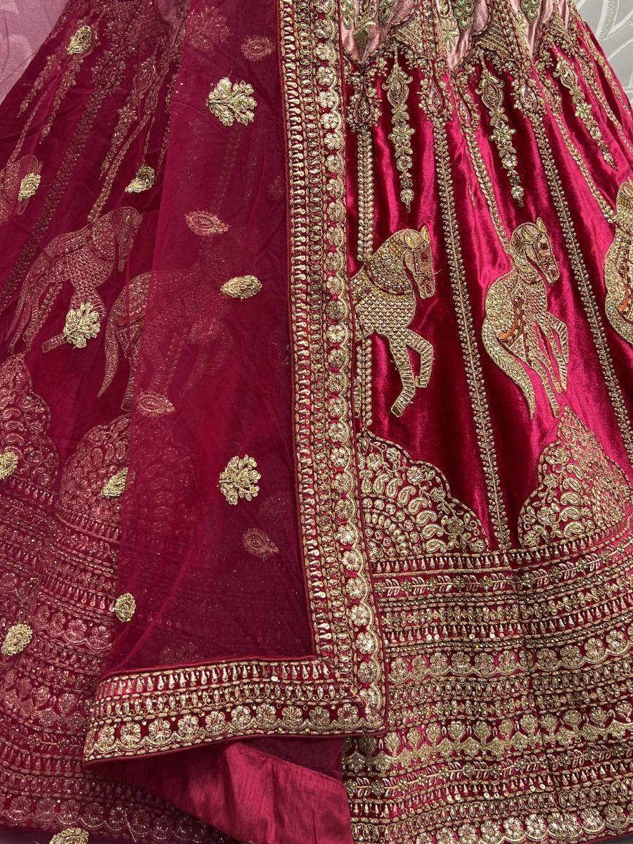 Maroon velvet lehenga with gold horse embroidery and intricate zari work, perfect for Indian weddings.