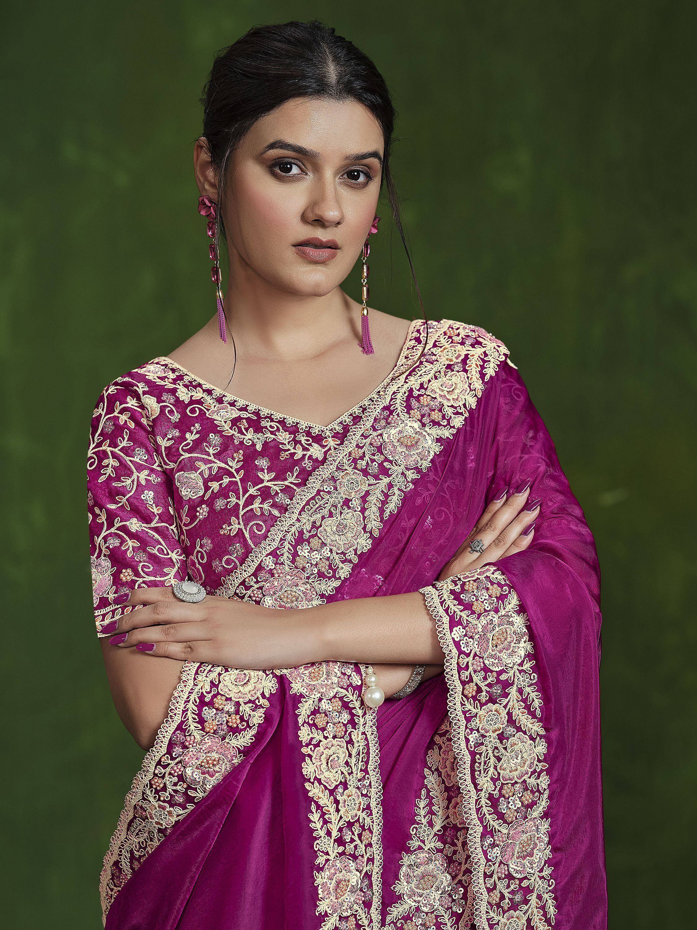 Woman in purple embroidered Indian ethnic saree with gold floral detailing, perfect for festive occasions