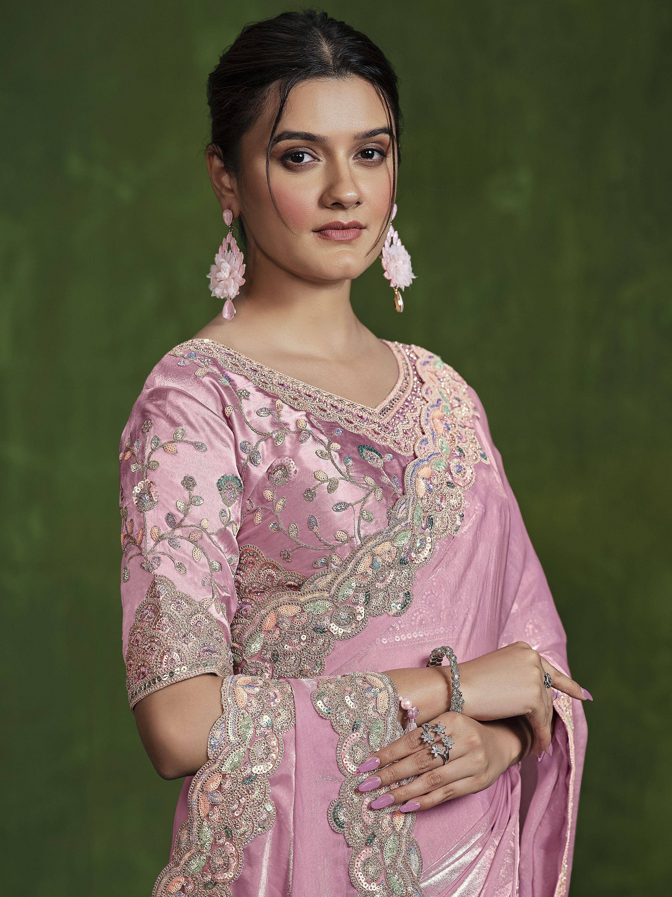 Pink embroidered designer salwar kameez with floral detailing and statement earrings for festive occasions
