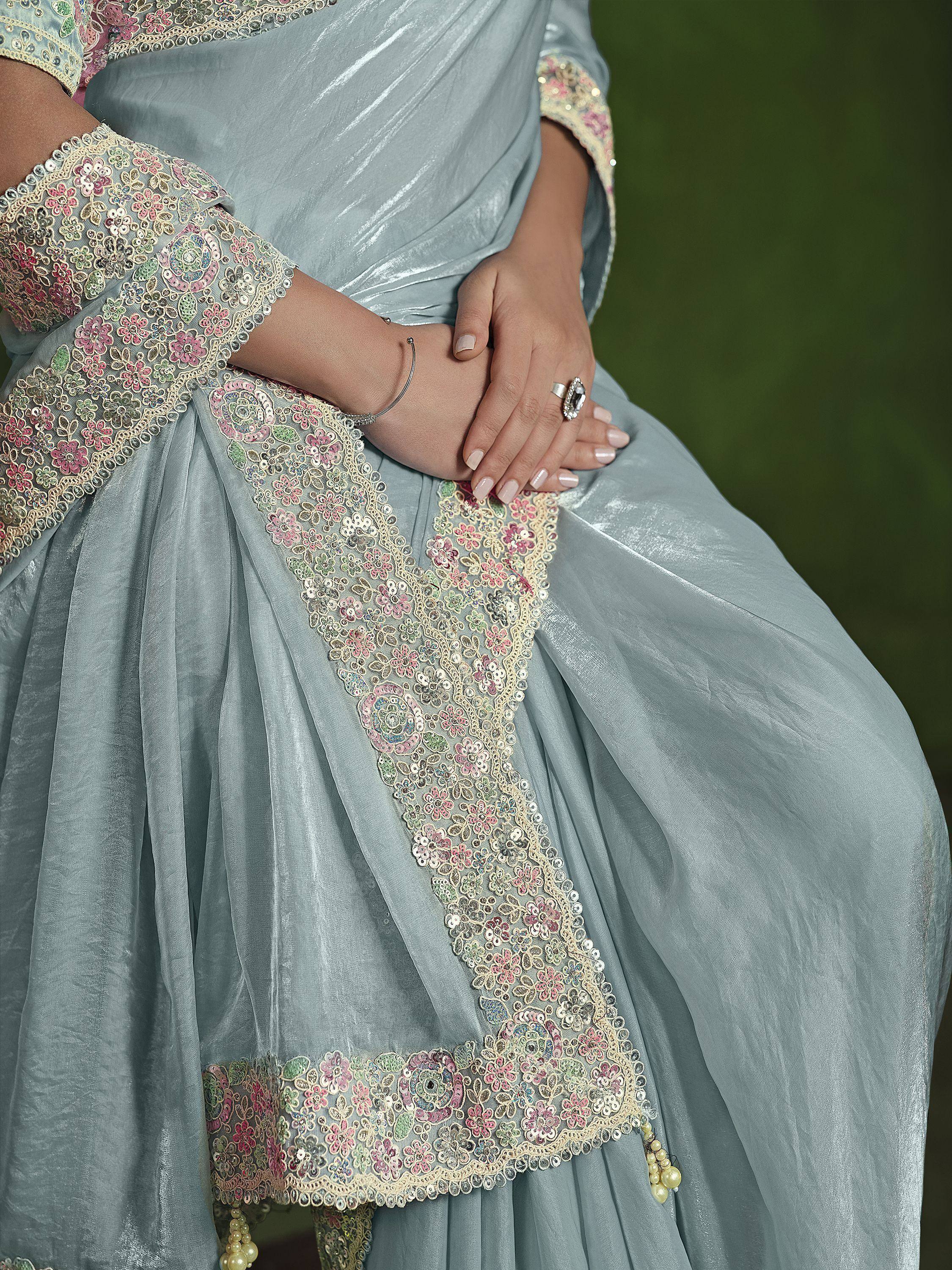 Light blue ethnic gown with floral sequin embroidery and lace trim, perfect for festive occasions.