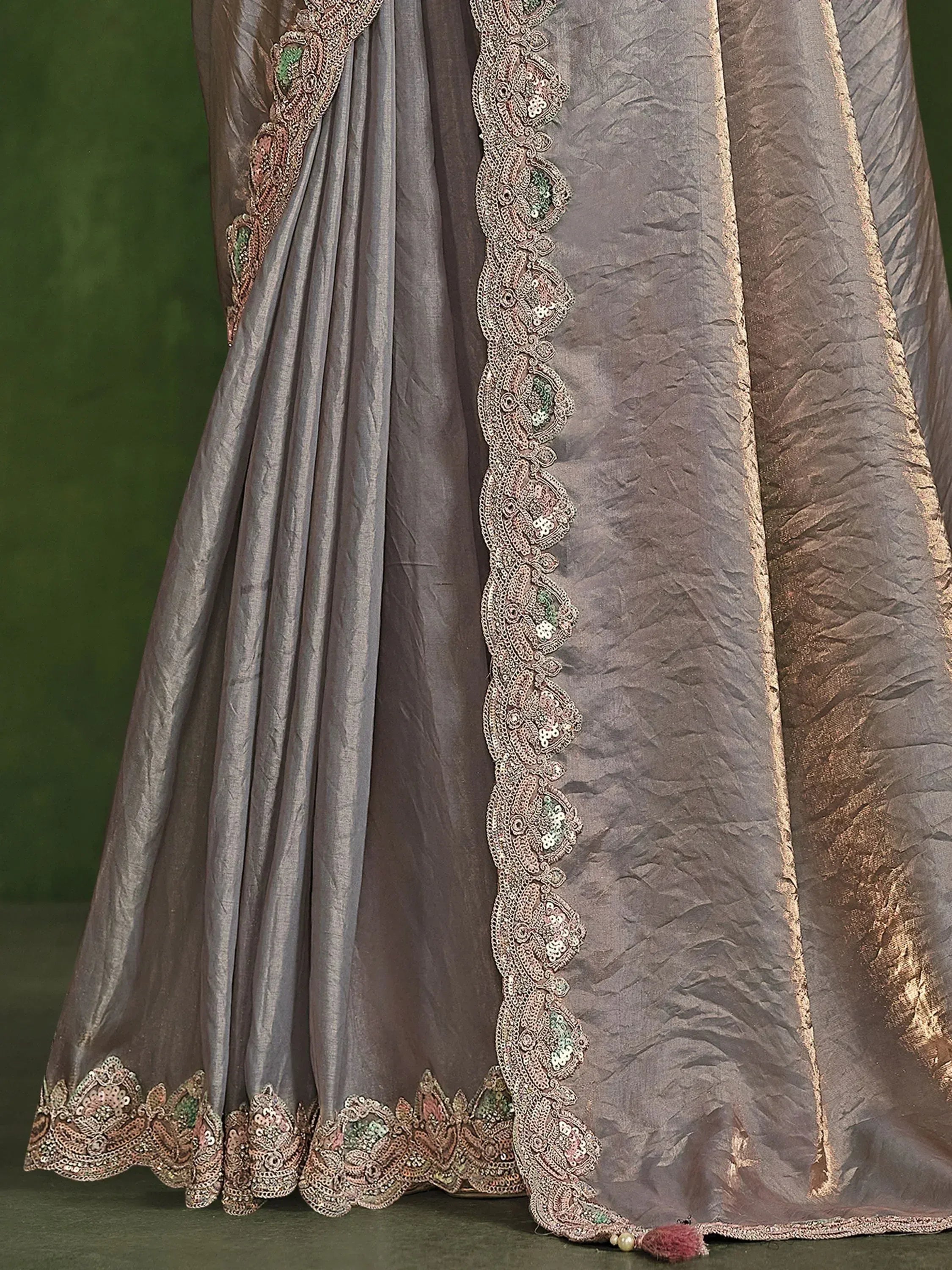 Grey designer saree with intricate gold and green embroidery, perfect for ethnic occasions.