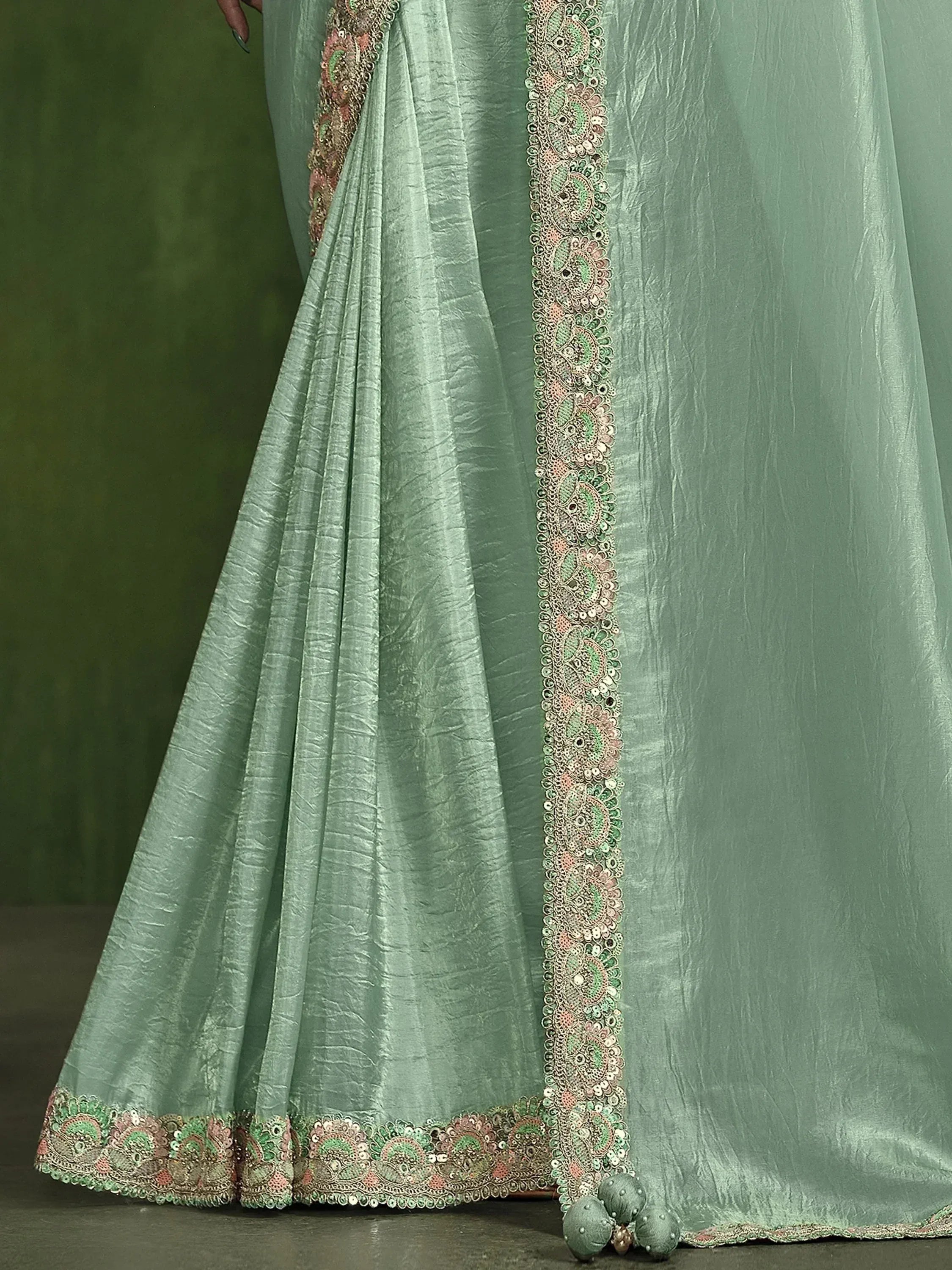 Mint green saree with intricate floral embroidery and sequin border, perfect for ethnic occasions