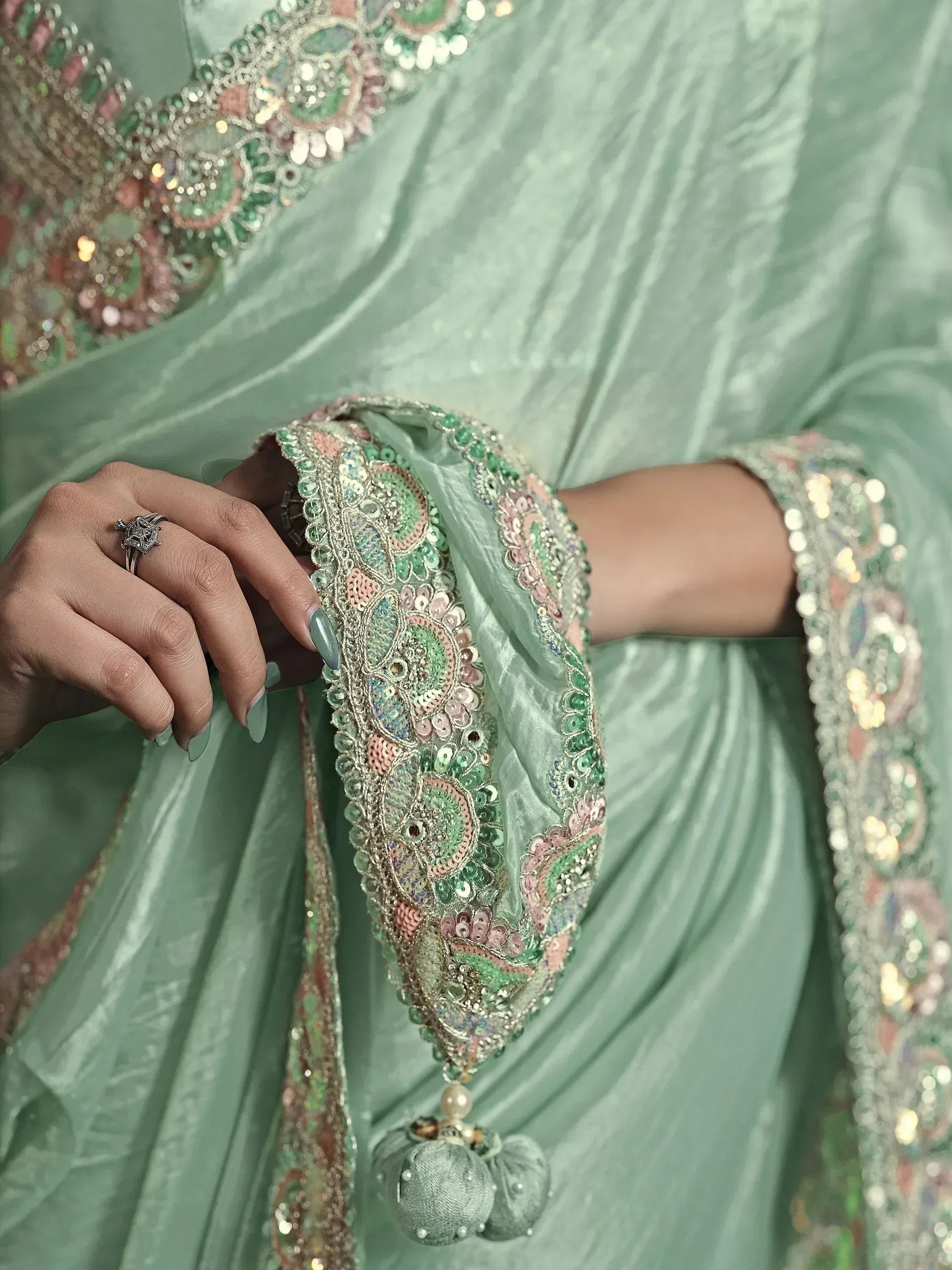 Mint green ethnic gown with intricate sequin and bead embroidery, perfect for Indian weddings or festive occasions.
