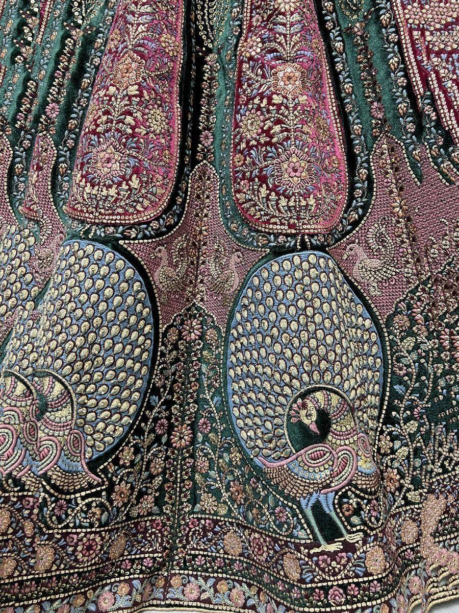 Intricate peacock and floral embroidery on Indian ethnic lehenga skirt, rich velvet fabric with gold detailing