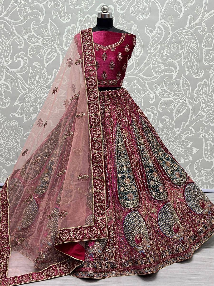 Maroon designer lehenga choli with peacock embroidery and sheer dupatta, perfect for Indian weddings and festive occasions.