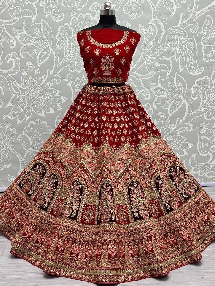 Red velvet lehenga choli with gold embroidery, perfect for Indian weddings and festive occasions