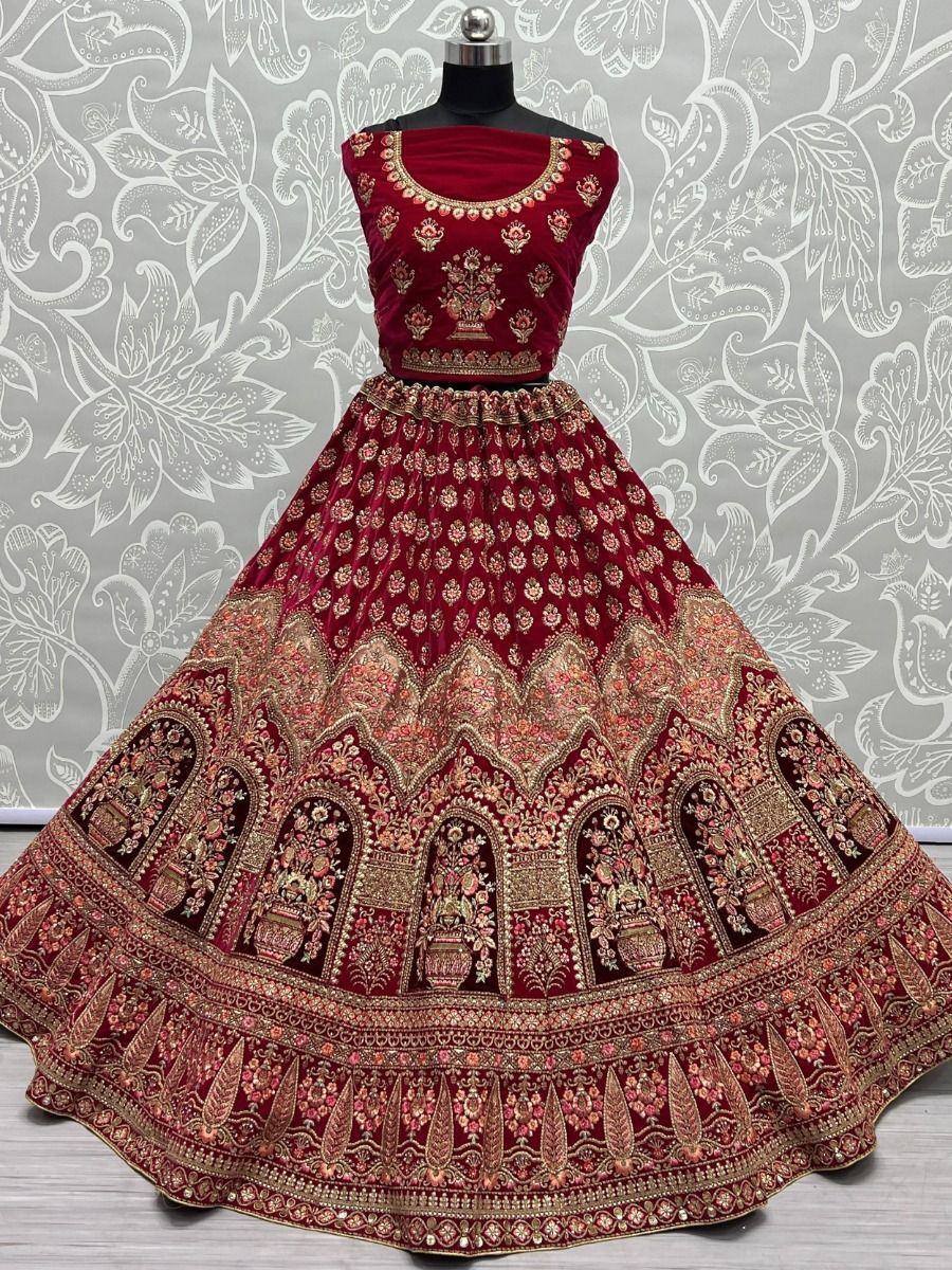Maroon velvet lehenga choli with gold embroidery, perfect for Indian weddings and festive occasions.