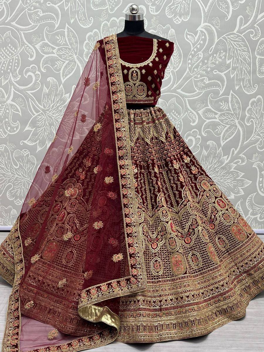 Maroon velvet lehenga choli with gold embroidery and matching dupatta, ideal for weddings and festive occasions