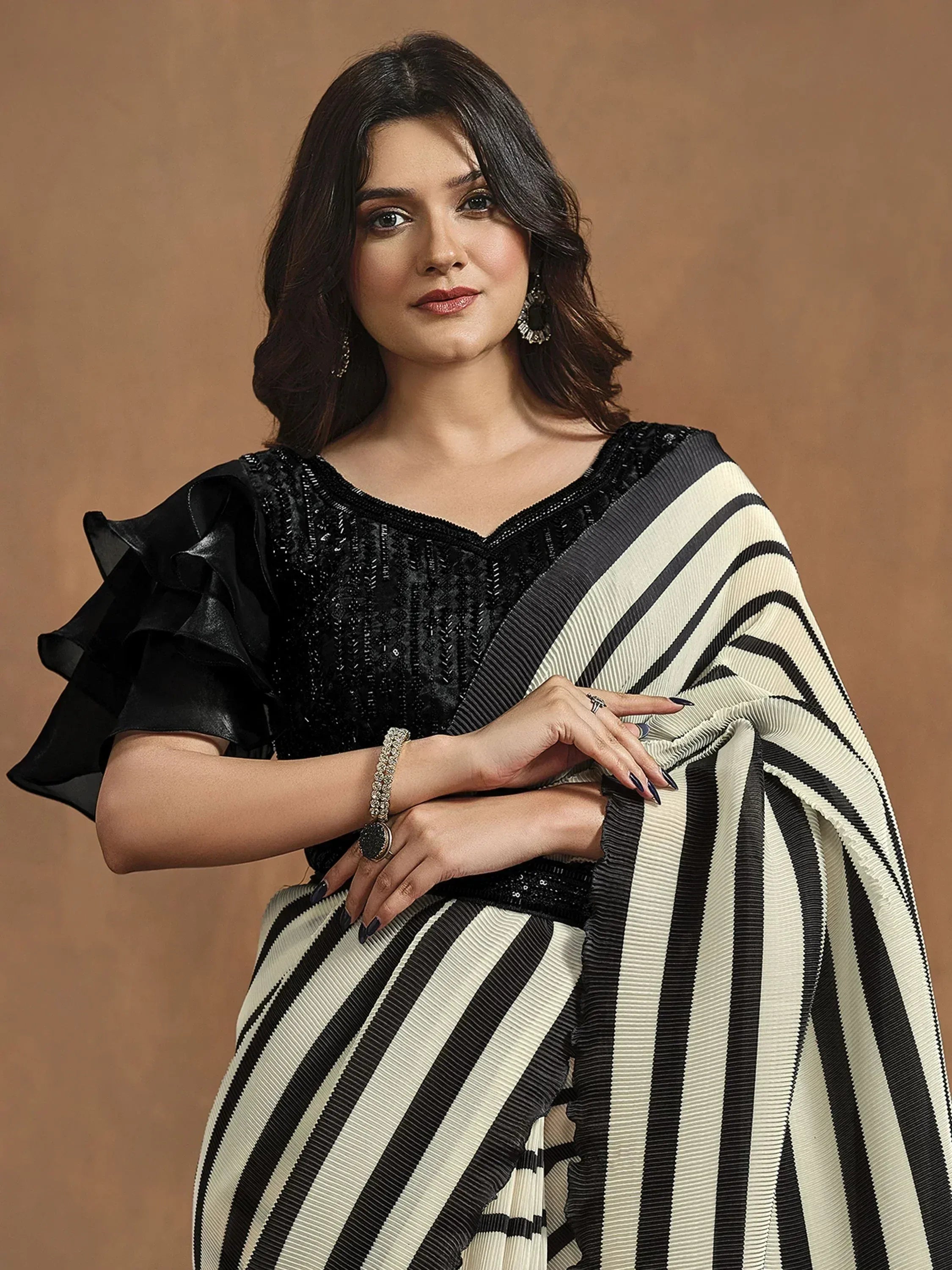 Elegant black and cream striped saree with sequin blouse, perfect for Indian ethnic wear occasions.