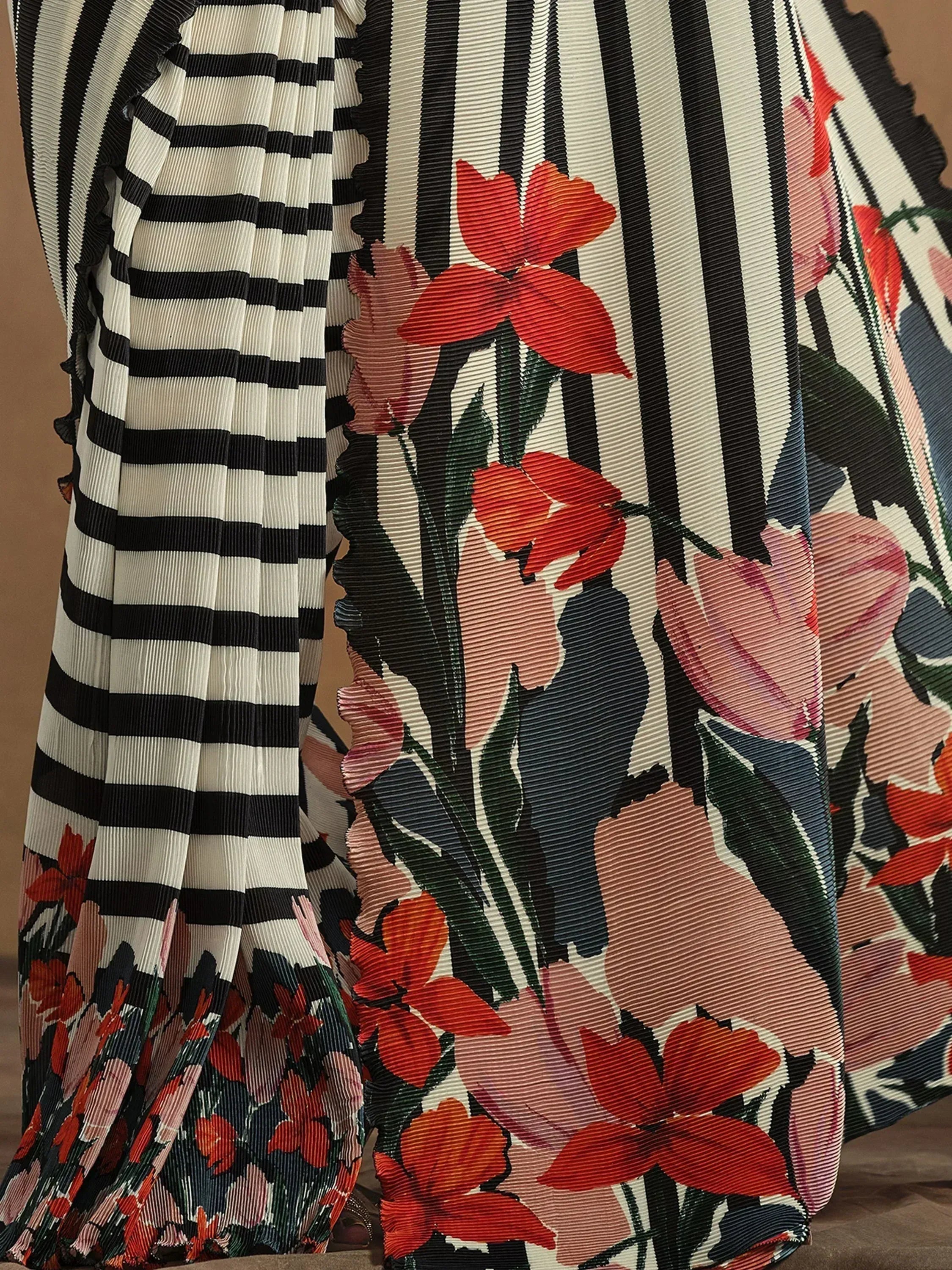 Black and white striped ethnic gown with vibrant floral print, perfect for Indian festive wear.