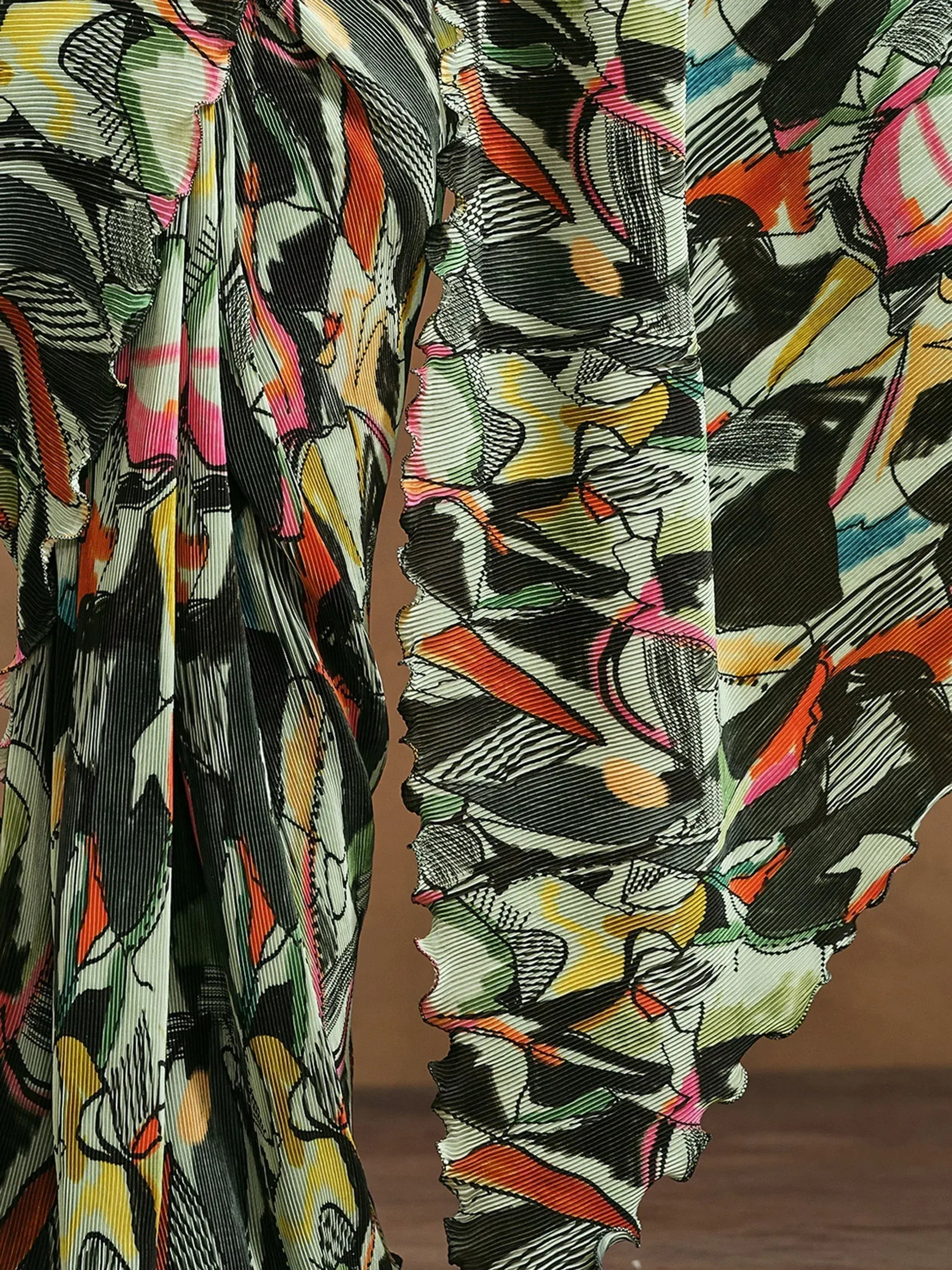 Vibrant abstract print ethnic gown with ruffled sleeves and pleated fabric details