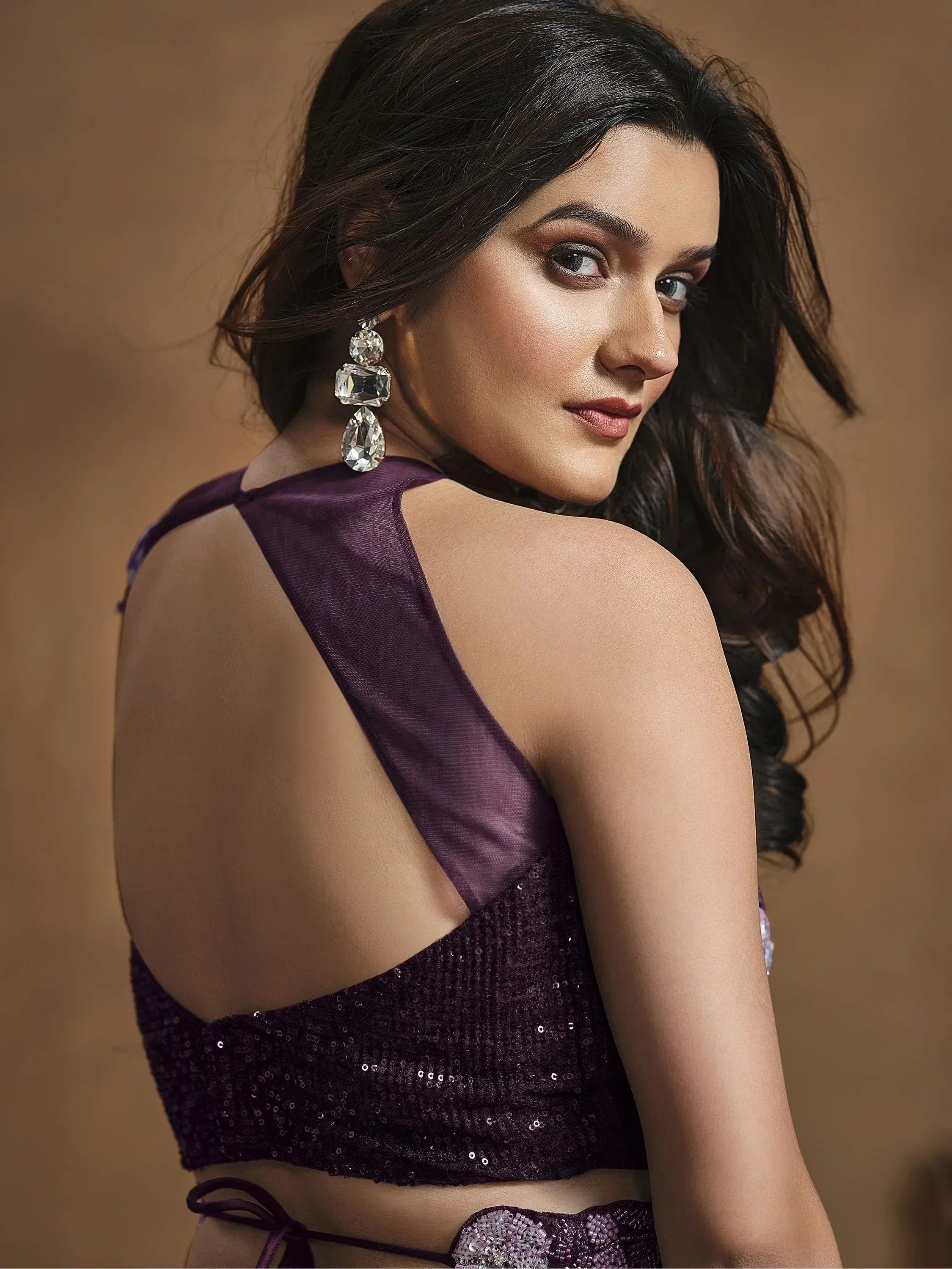 Purple sequin lehenga choli with backless blouse and statement earrings, ethnic Indian wear