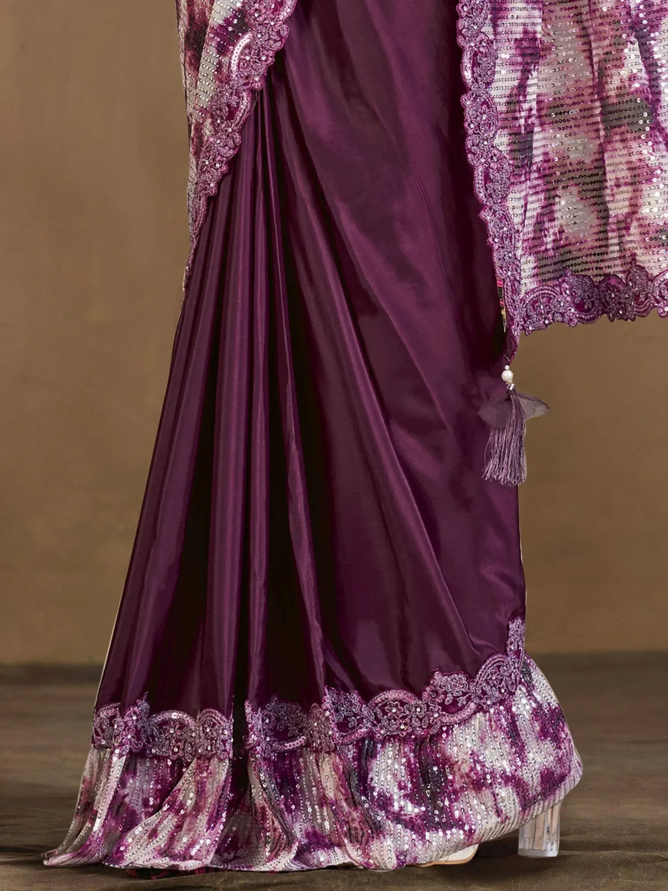 Purple ethnic gown with sequin lace detailing and tassel, perfect for Indian weddings or festive occasions
