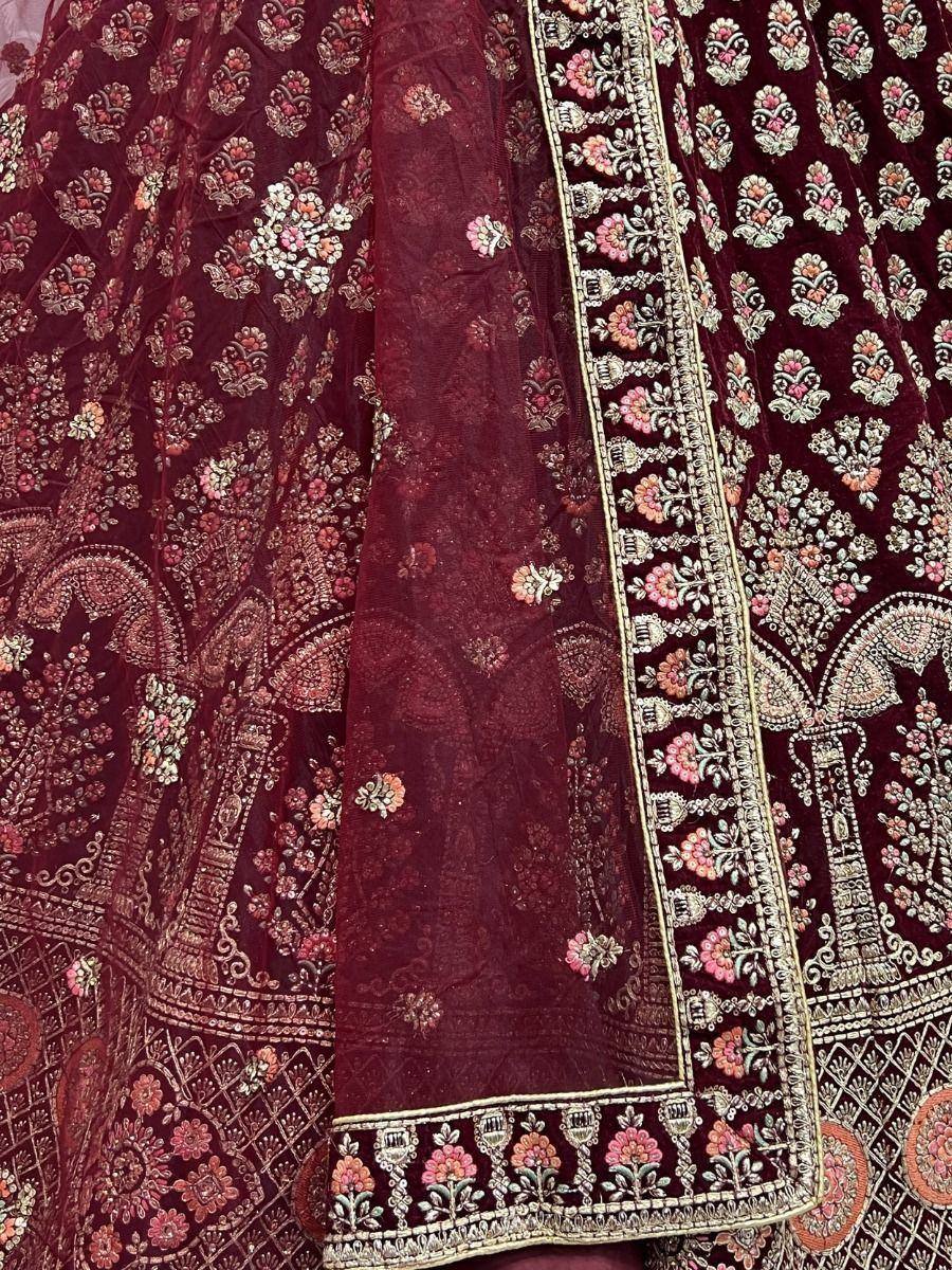 Maroon velvet lehenga with intricate floral embroidery and gold border detailing