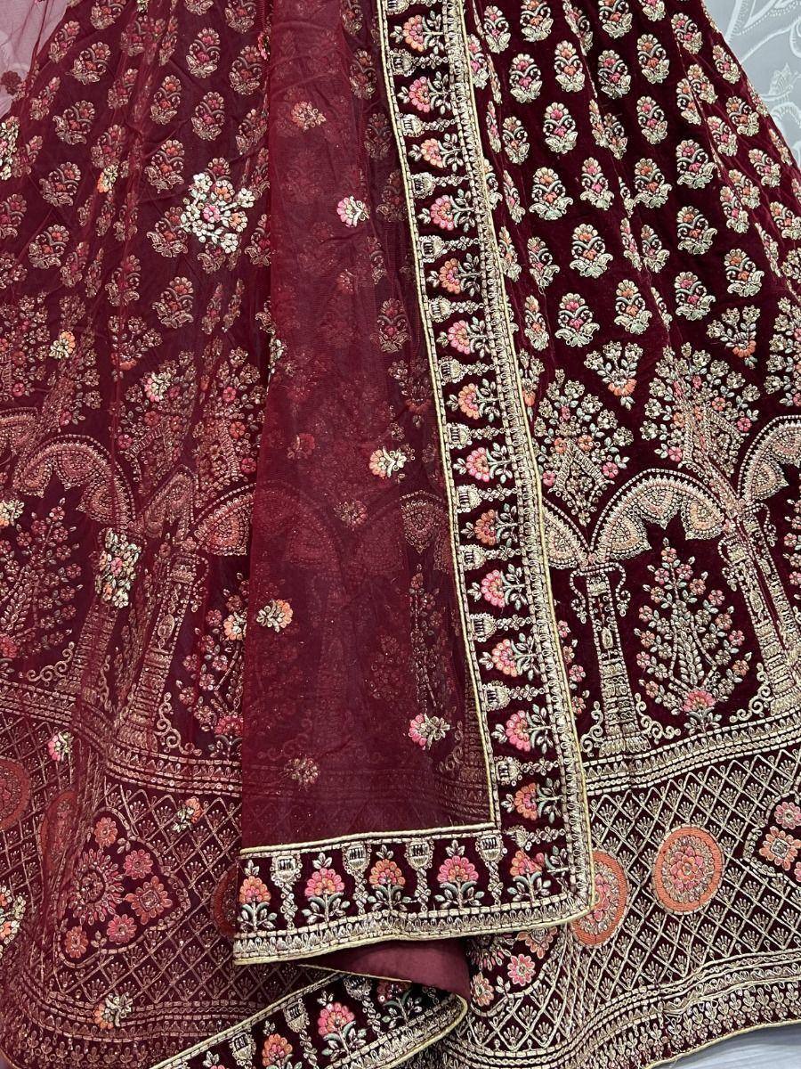 Maroon velvet lehenga choli with intricate floral embroidery and gold detailing, perfect for Indian ethnic wear.
