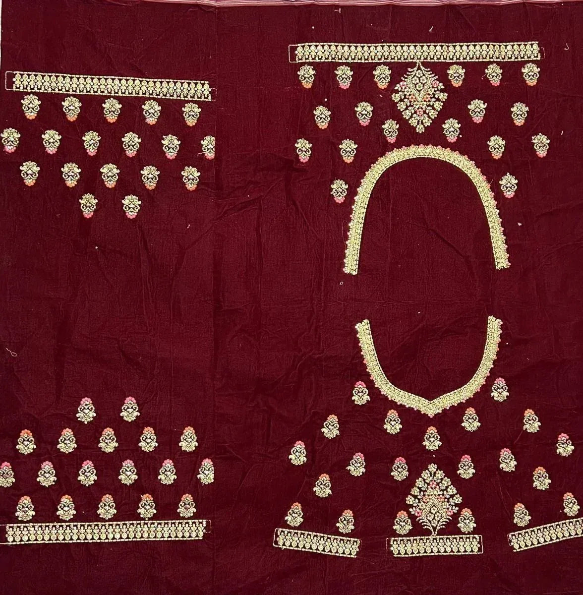 Maroon ethnic wear fabric with gold and pink floral embroidery, perfect for designer lehenga or salwar kameez.