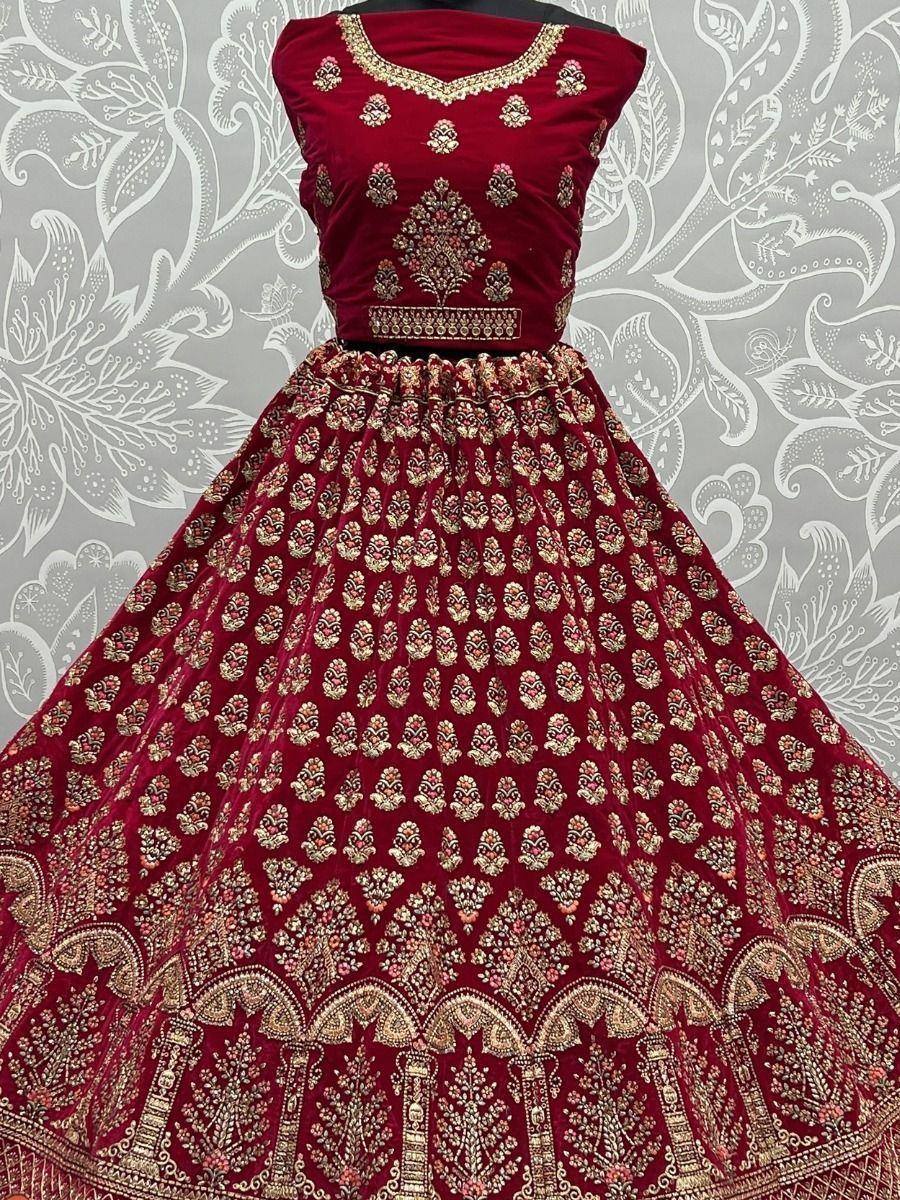 Maroon velvet lehenga choli with gold embroidery, perfect for Indian weddings and festive occasions.