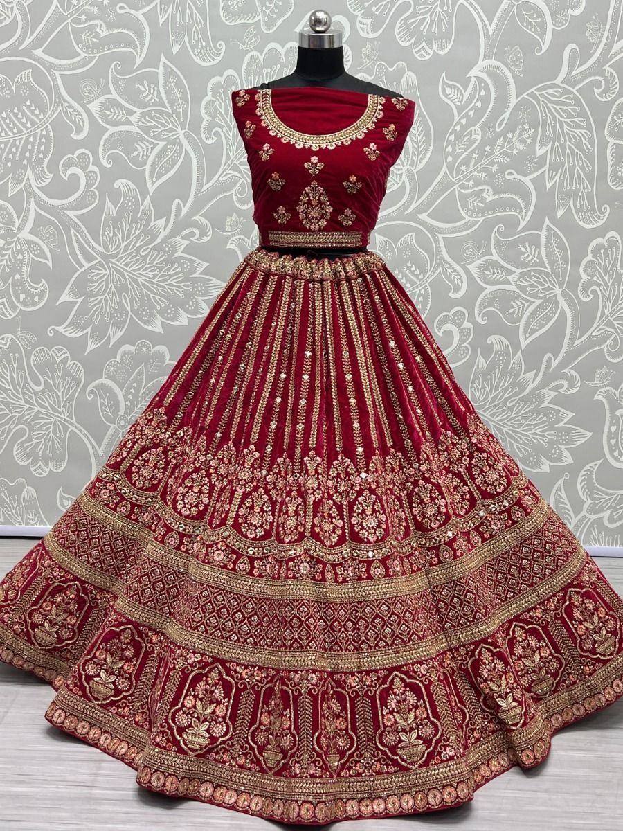 Maroon velvet lehenga choli with gold embroidery, perfect for Indian weddings and festive occasions.