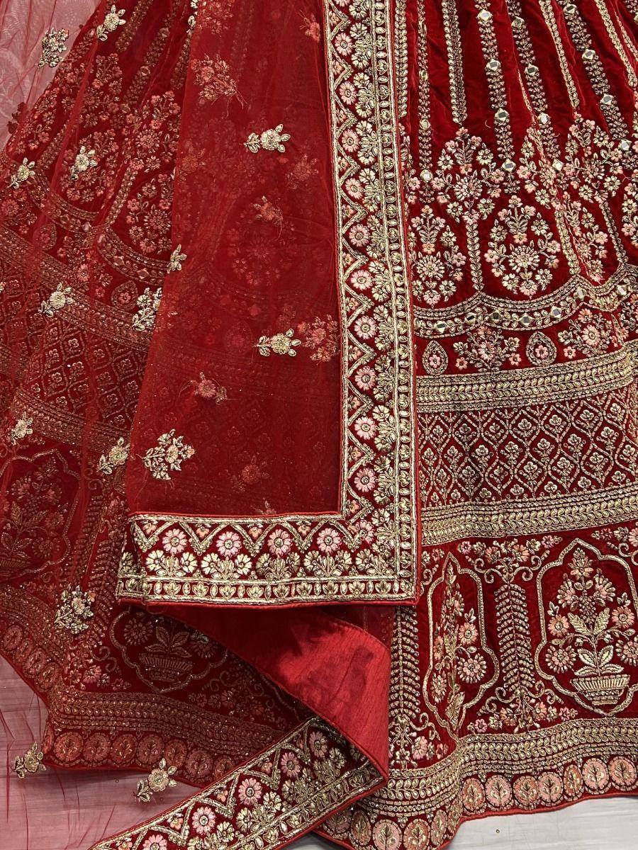 Red velvet lehenga choli with gold floral embroidery and mirror work, perfect for Indian weddings