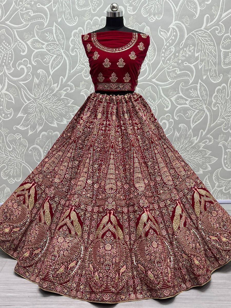 Maroon velvet lehenga choli with gold embroidery, perfect for Indian weddings and festive occasions.