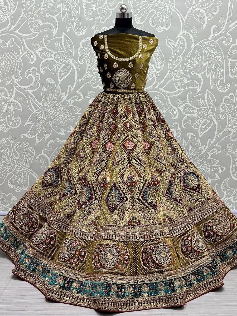 Olive green velvet lehenga choli with heavy gold embroidery and geometric patterns, perfect for weddings