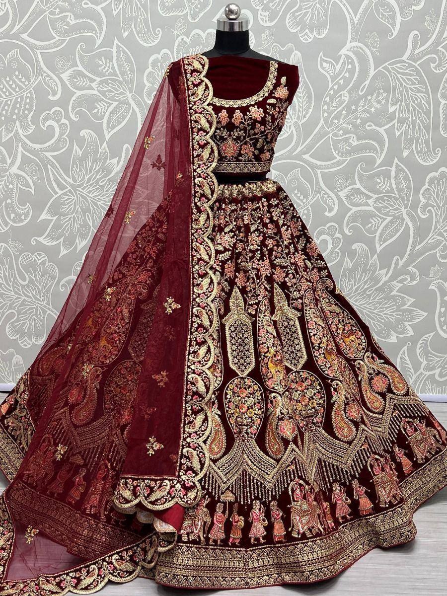 Maroon velvet lehenga choli with gold embroidery and sheer dupatta, perfect for Indian weddings and festive occasions.