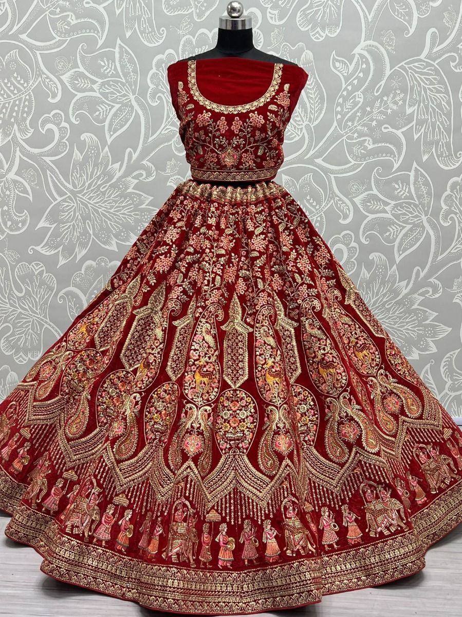 Red velvet lehenga choli with gold embroidery, perfect for Indian weddings and festive occasions.