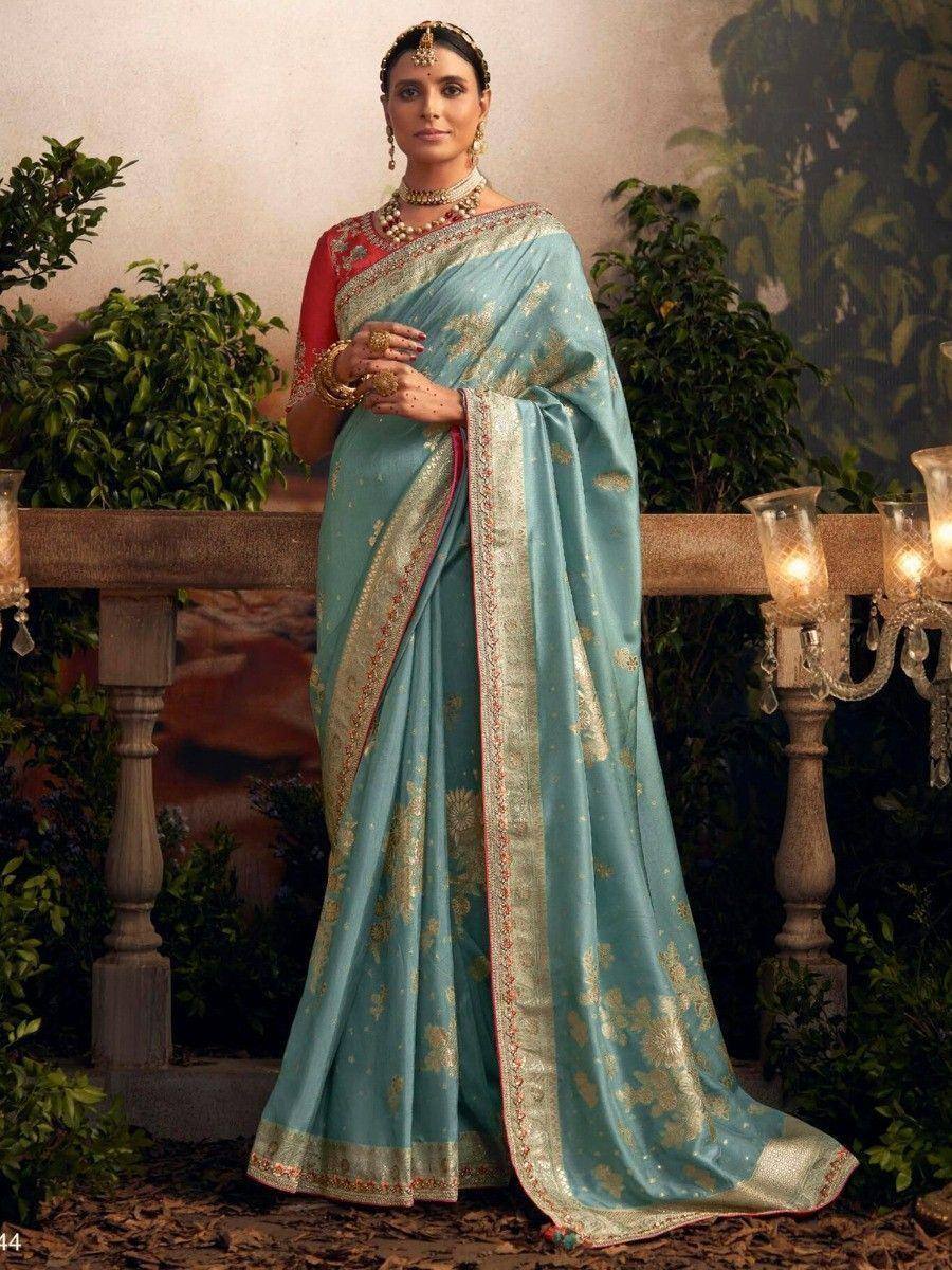 Elegant light blue saree with gold floral motifs and red blouse, perfect for Indian ethnic occasions