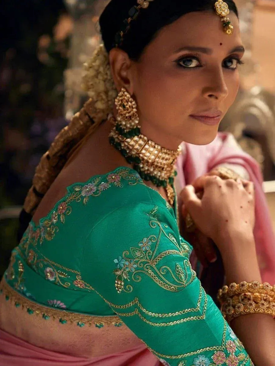 Elegant woman in green embroidered lehenga choli with gold jewelry, traditional Indian ethnic wear