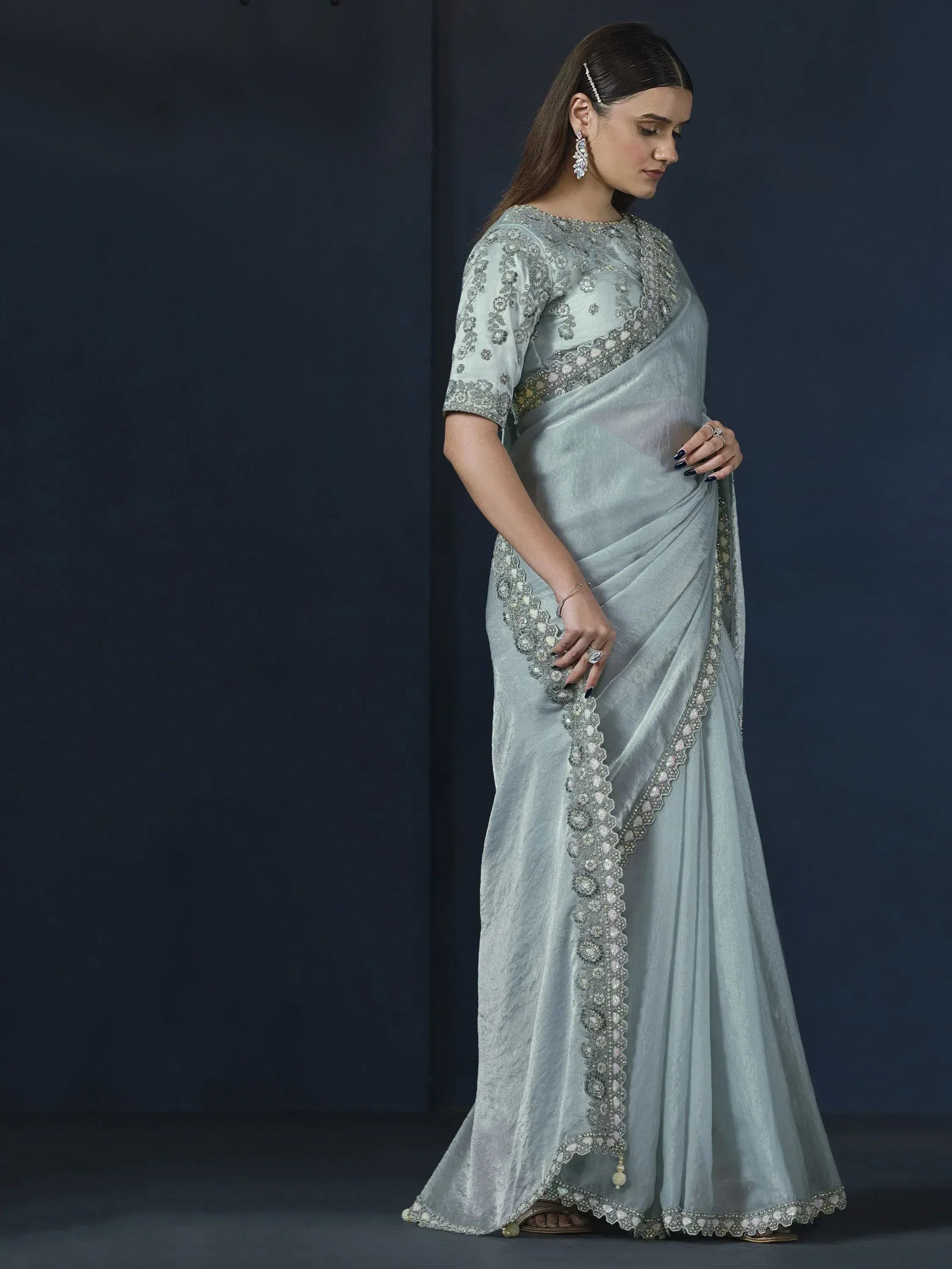 Elegant light blue saree with intricate silver embroidery and embellished border, perfect for Indian ethnic occasions.