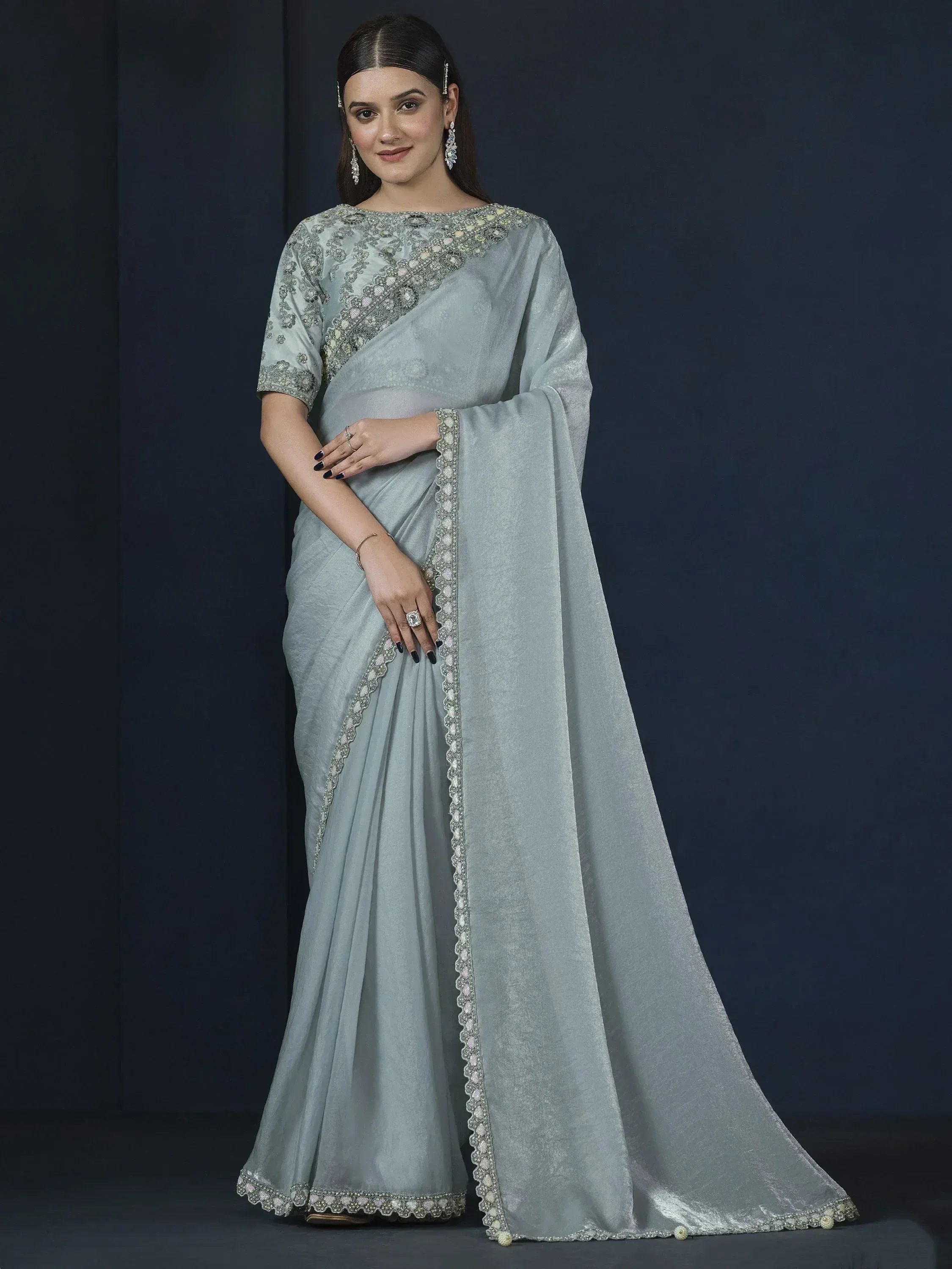 Elegant light blue saree with intricate embroidery and embellished border, perfect for Indian ethnic occasions